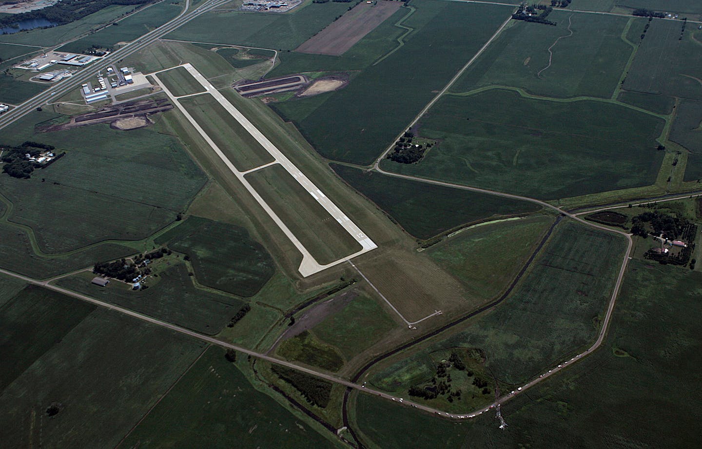 Investigators examined the scene of an airplane crash (bottom right past runway) at the Owatonna airport where at least eight people were reported killed.