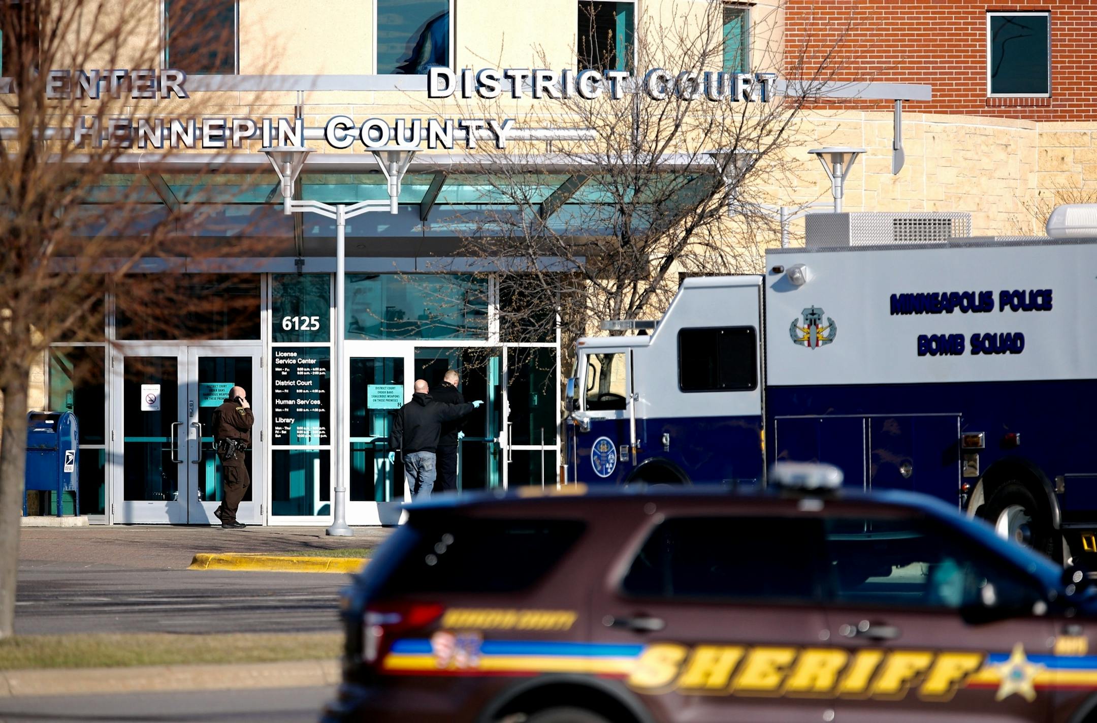 A Minneapolis police bomb squad van and Hennepin County Sheriff vehicles are seen parked outside the Hennepin County Regional Center Brookdale in Brooklyn Center after a pipe bomb threat on Friday, April 1, 2016.