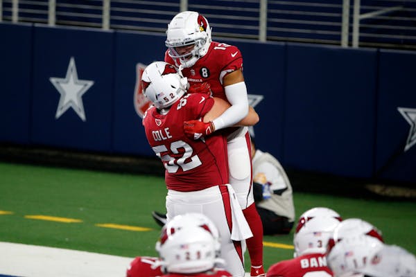 Mason Cole (52) celebrated a touchdown with Christian Kirk (13) for Arizona in October. 
