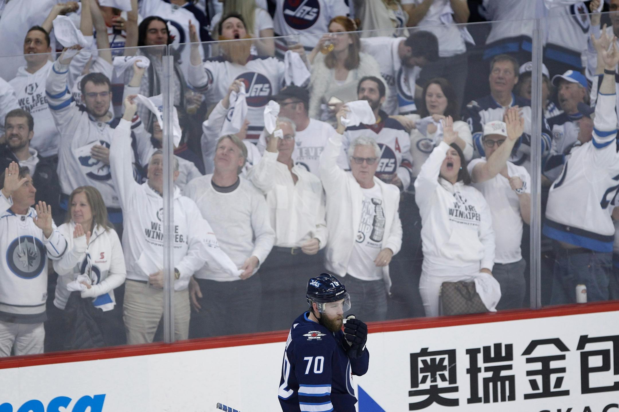 Winnipeg Jets fans celebrate Joe Morrow's goal against the Minnesota Wild during the third period of Game 1 in an NHL hockey first-round playoff series Wednesday, April 11, 2018, in Winnipeg, Manitoba.