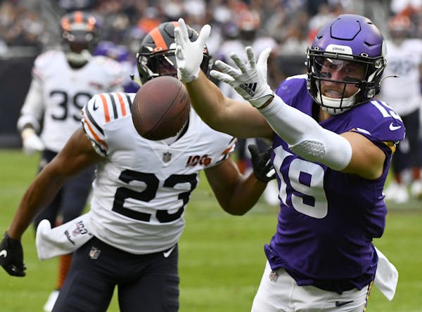 Minnesota Vikings wide receiver Adam Thielen, right, misses a pass as Chicago Bears cornerback Kyle Fuller (23) defends during the first half of an NF
