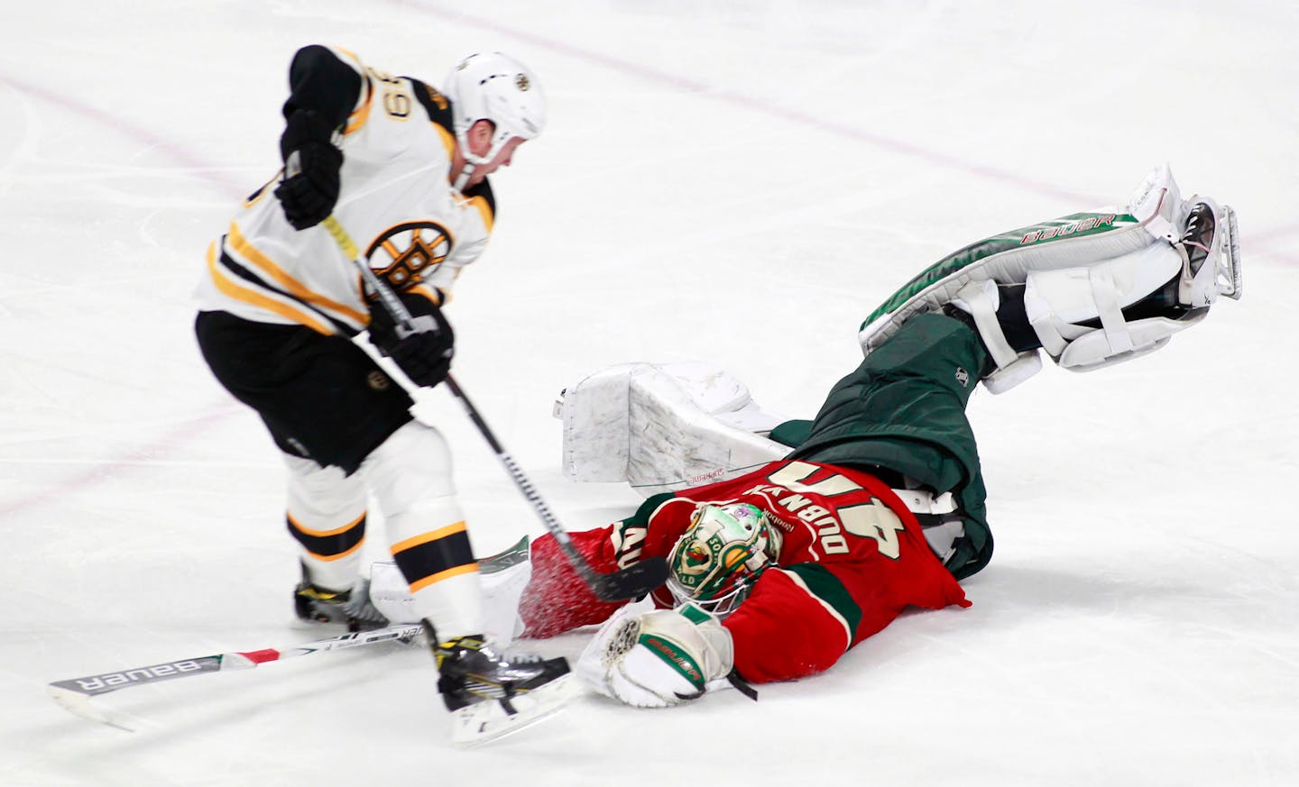 Minnesota Wild goalie Devan Dubnyk (40) comes out to make a save on a break away by Boston Bruins left wing Matt Beleskey (39) during the third period of an NHL hockey game, Thursday, Nov. 17, 2016, in St. Paul, Minn. Minnesota won 1-0. (AP Photo/Paul Battaglia)