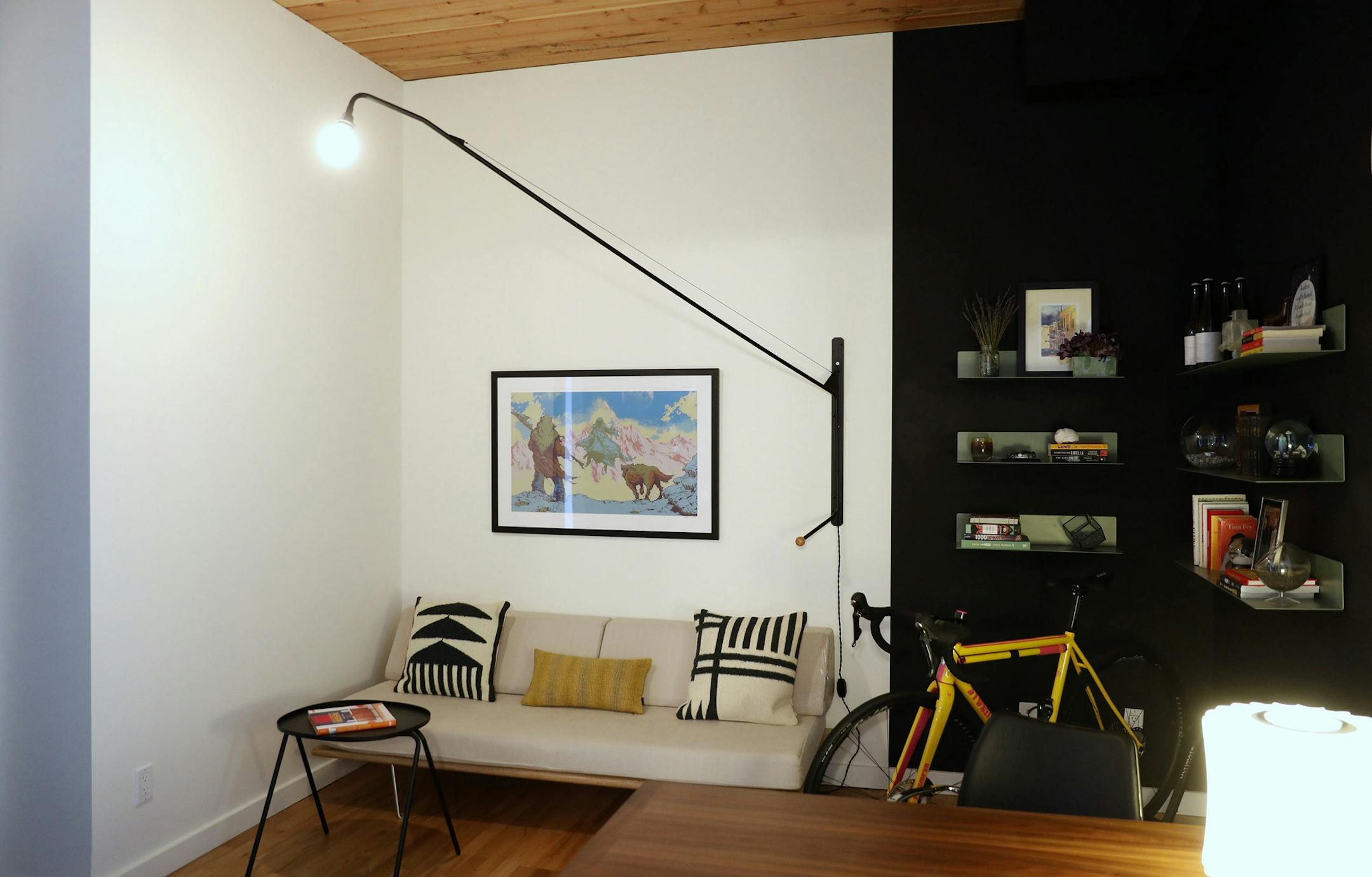 A swinging Prouve Potence wall lamp spotlights a daybed in the highly adaptable office, where the portable table works as a desk and a dining destination, and the daybed folds out into a bed for guests. "We'll do dinners in here and play Stratego," homeowner Max Lemman says. "I've never won." (Ken Lambert/The Seattle Times/TNS)