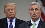President Donald Trump listens to House Minority Leader Kevin McCarthy of Calif., speaking in the Rose Garden of the White House in Washington, after 