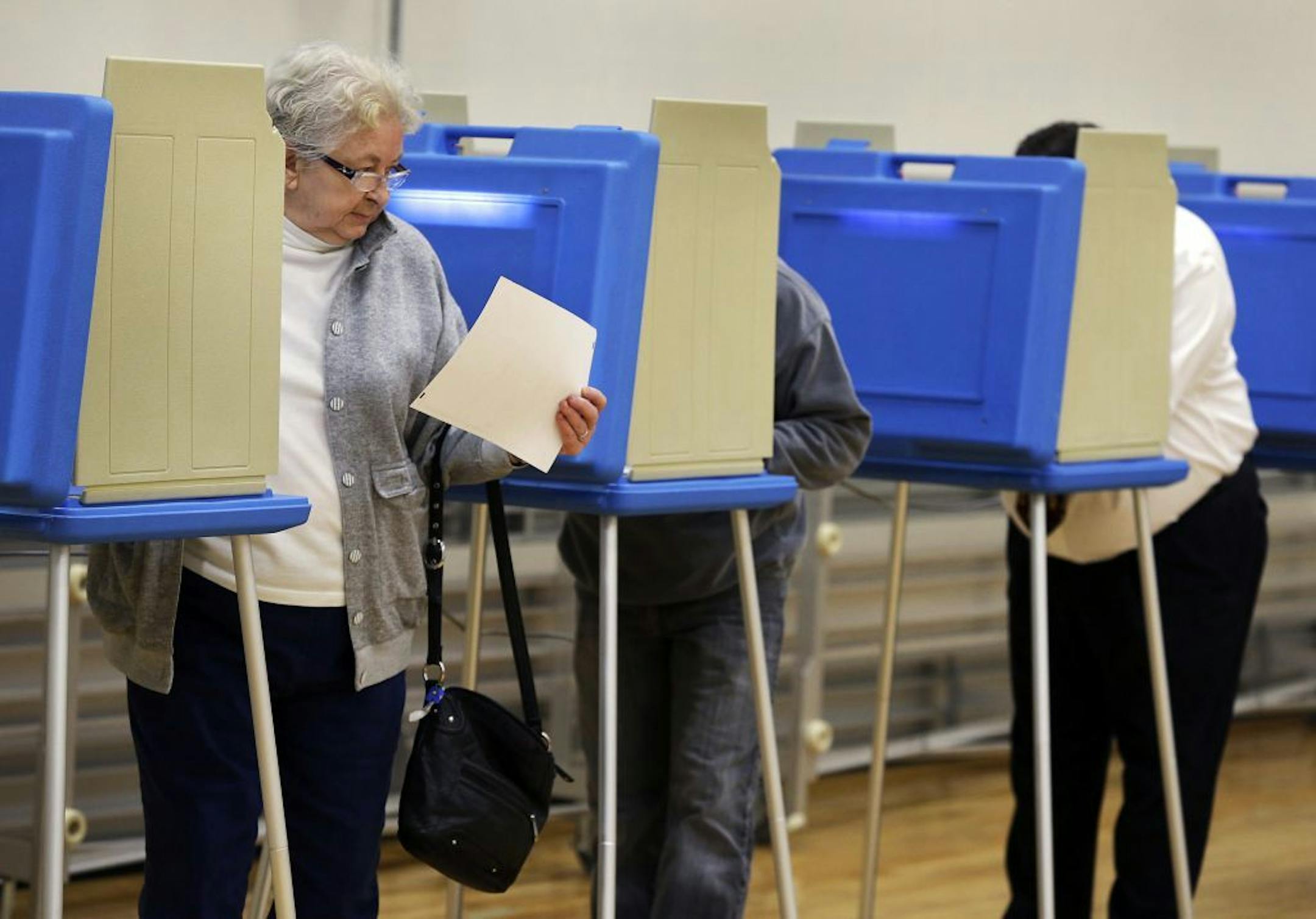 Appleton resident Donna Emrick finishes voting at Fox Valley Lutheran High School on Election Day, Tuesday, Nov. 6, 2012, in Appleton, Wis. (AP Photo/The Post-Crescent, Sharon Cekada)