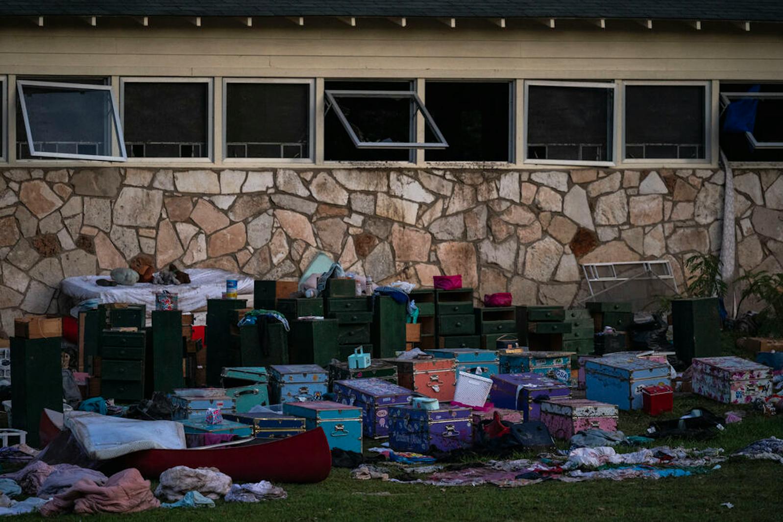Campers' belongings sit outside one of Camp Mystic's cabins near the Guadalupe River after a flash flood swept through the area, Monday, July 7, 2025, in Hunt, Texas.