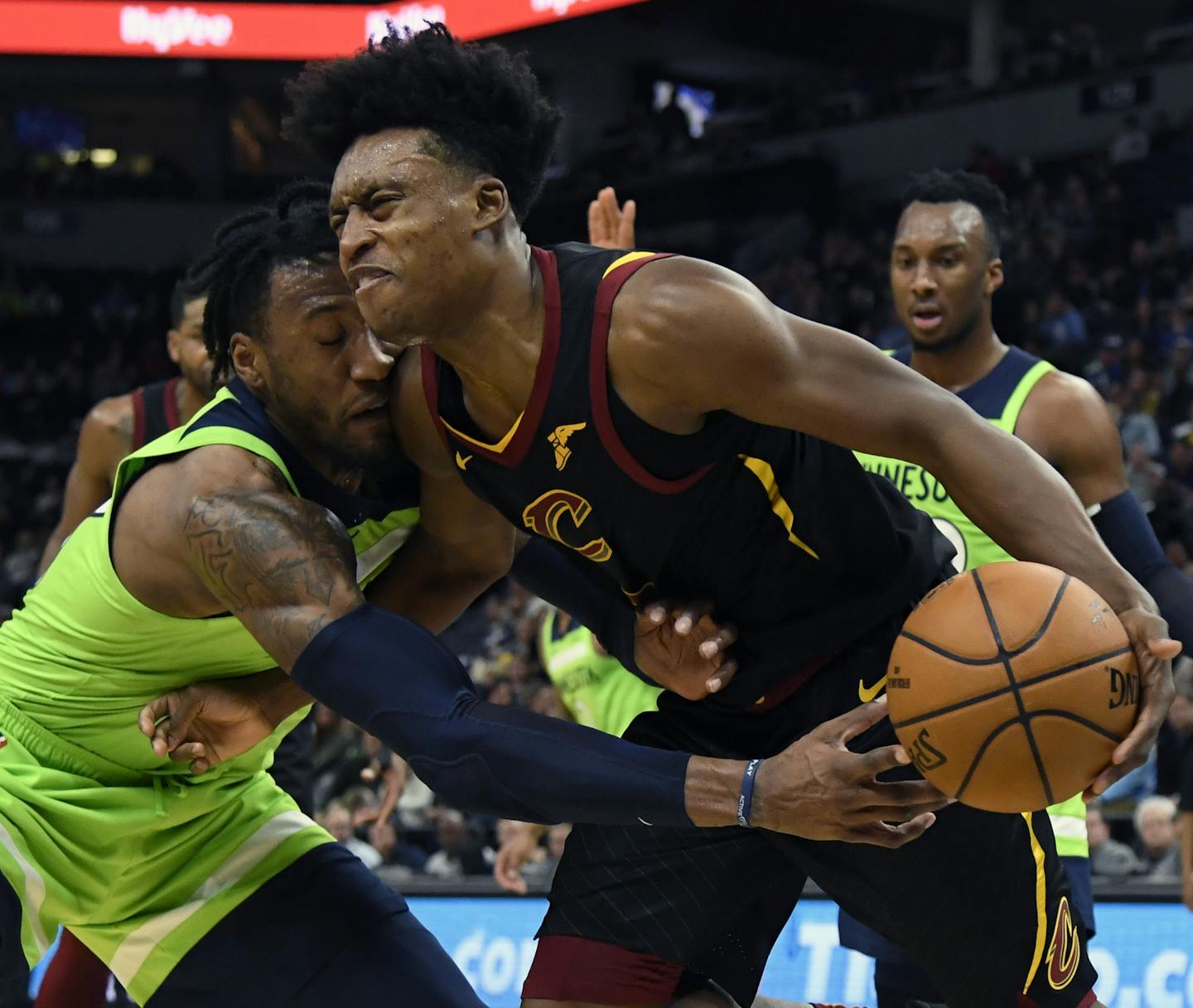 Minnesota Timberwolves' Robert Covington (33) reaches for the ball controlled by Cleveland Cavaliers' Collin Sexton (2) during the second quarter of an NBA basketball game on Saturday, Dec. 28, 2019, in Minneapolis. (AP Photo/Hannah Foslien)