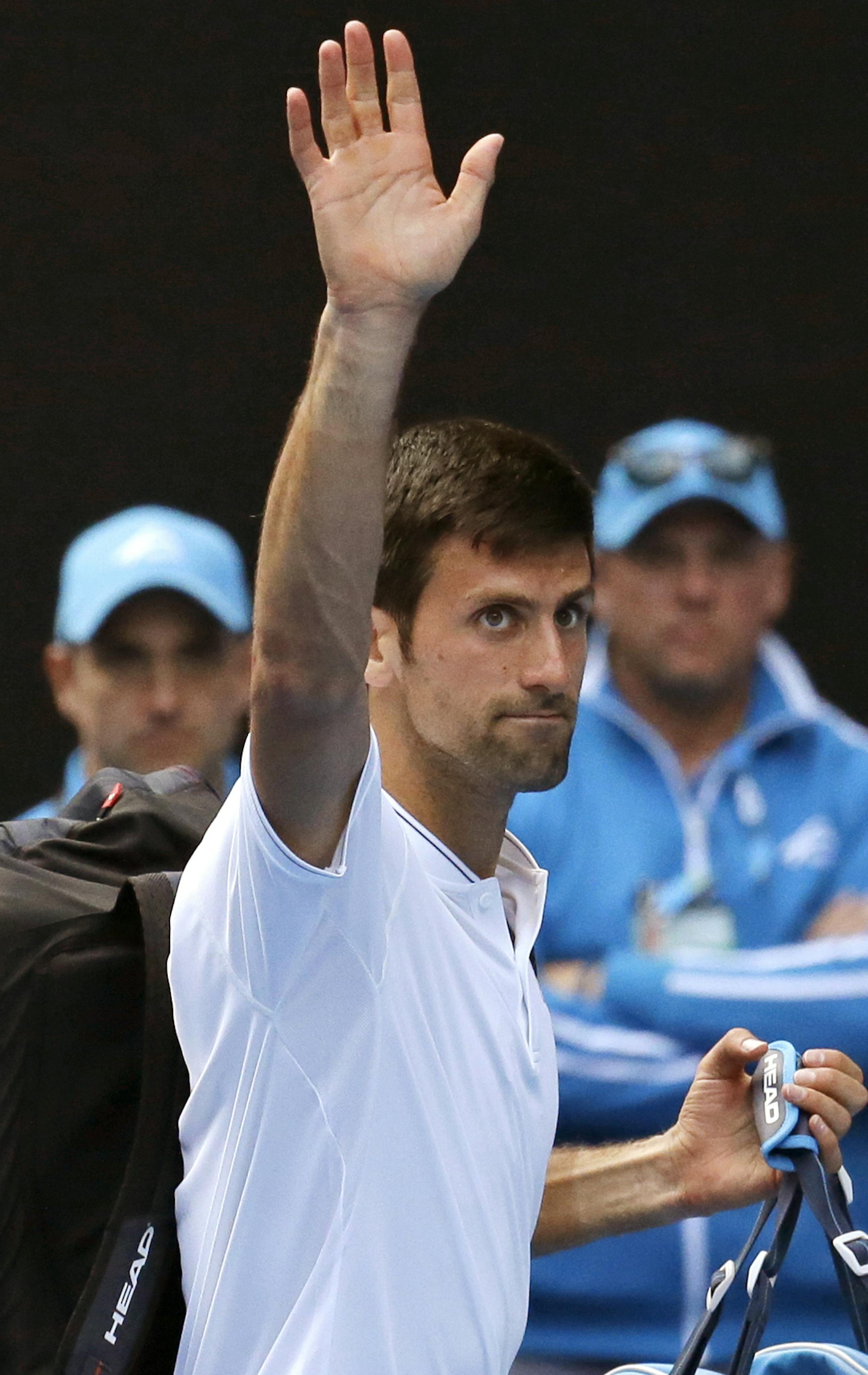 Serbia's Novak Djokovic leaves Rod Laver Arena after his second round loss to Uzbekistan's Denis Istomin at the Australian Open tennis championships in Melbourne, Australia, Thursday, Jan. 19, 2017. (AP Photo/Aaron Favila)