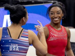 Suni Lee and Simone Biles chat during a practice at Target Center on Wednesday ahead of the United States Olympic gymnastics trials.