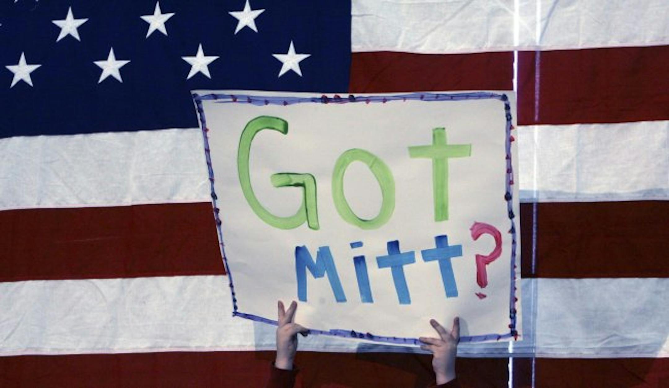 A supporter holds up a sign for Republican presidential hopeful, former Massachusetts Gov. Mitt Romney, during a campaign stop in Nashua, N.H., Sunday, Jan. 6, 2008.