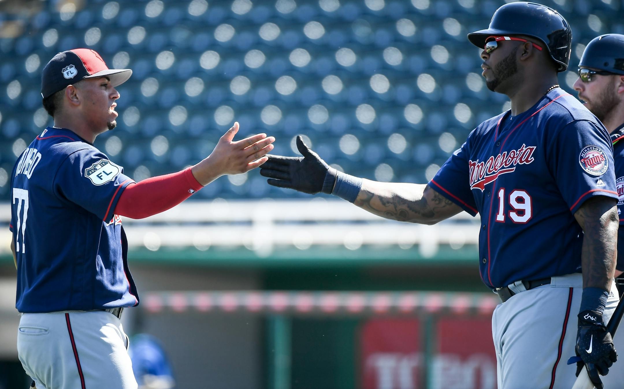 Minnesota Twins pitching prospect Fernando Romero (77) high fived first baseman Kennys Vargas (19) after Romero finished throwing during live batting practice Monday.