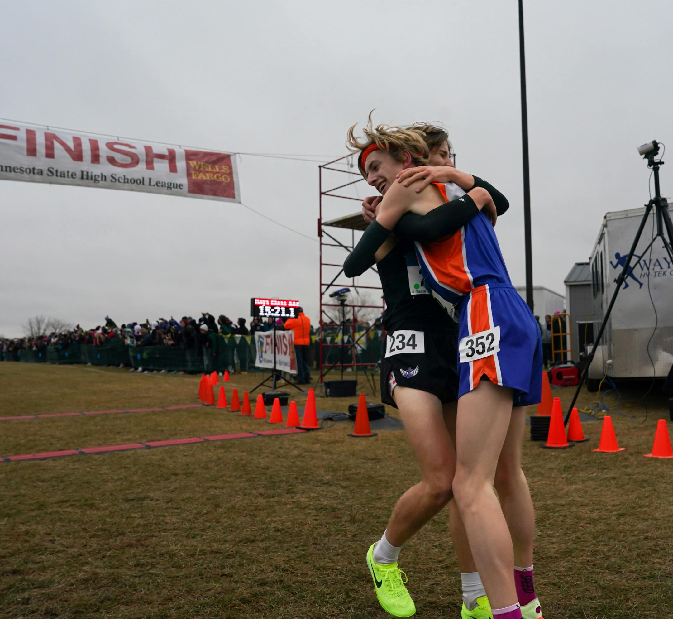 Aiden Jones, right, and Sam Scott hug after completing the 3A boys cross country race. Jones won the race with Scott coming in second.
