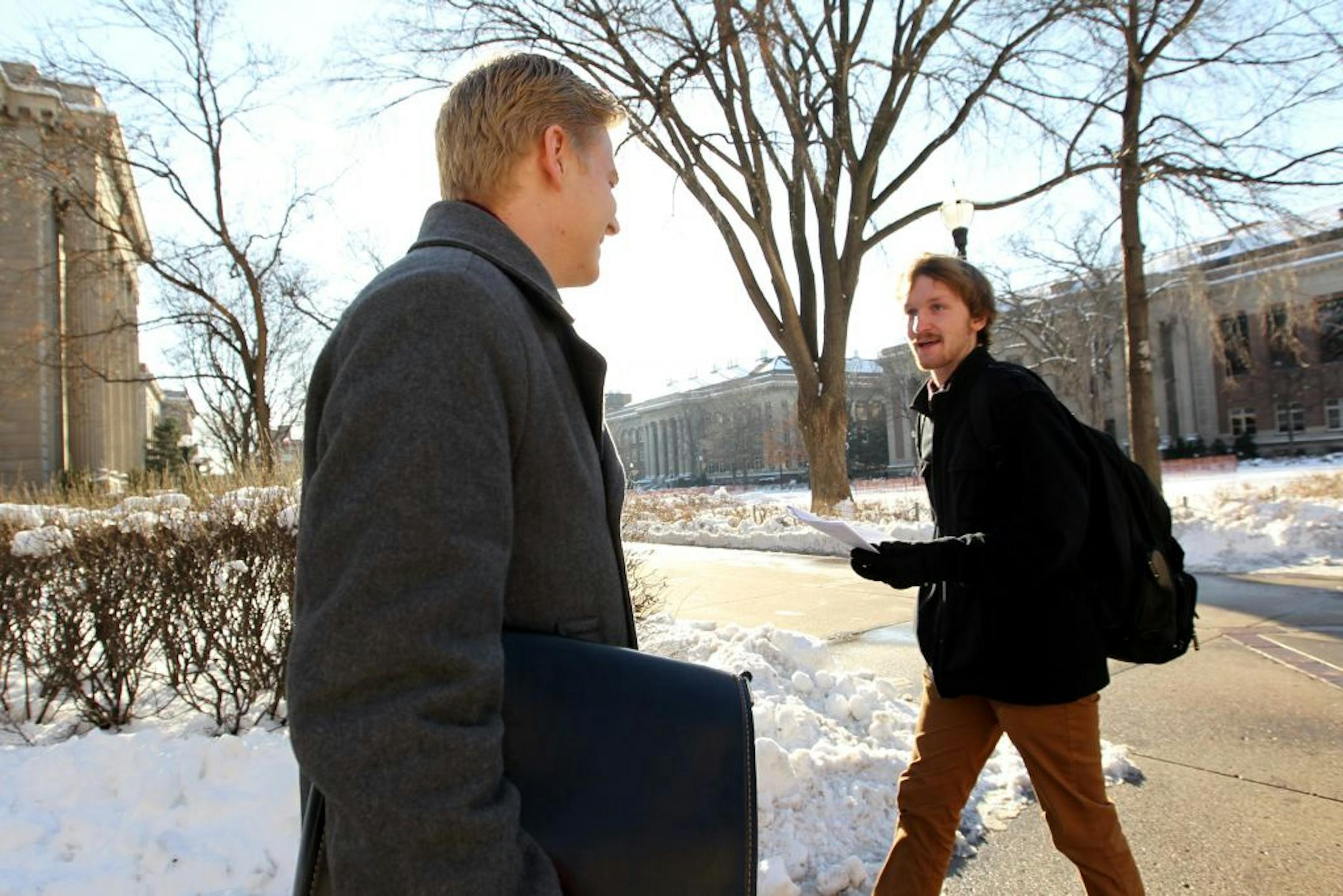 Nate Schwab, left, greeted a friend on the University of Minnesota campus in Minneapolis. Even with help from his parents, Schwab says tuition has been a hurdle for his pursuit of a degree. He works 40 hours a week while taking a full load of classes.