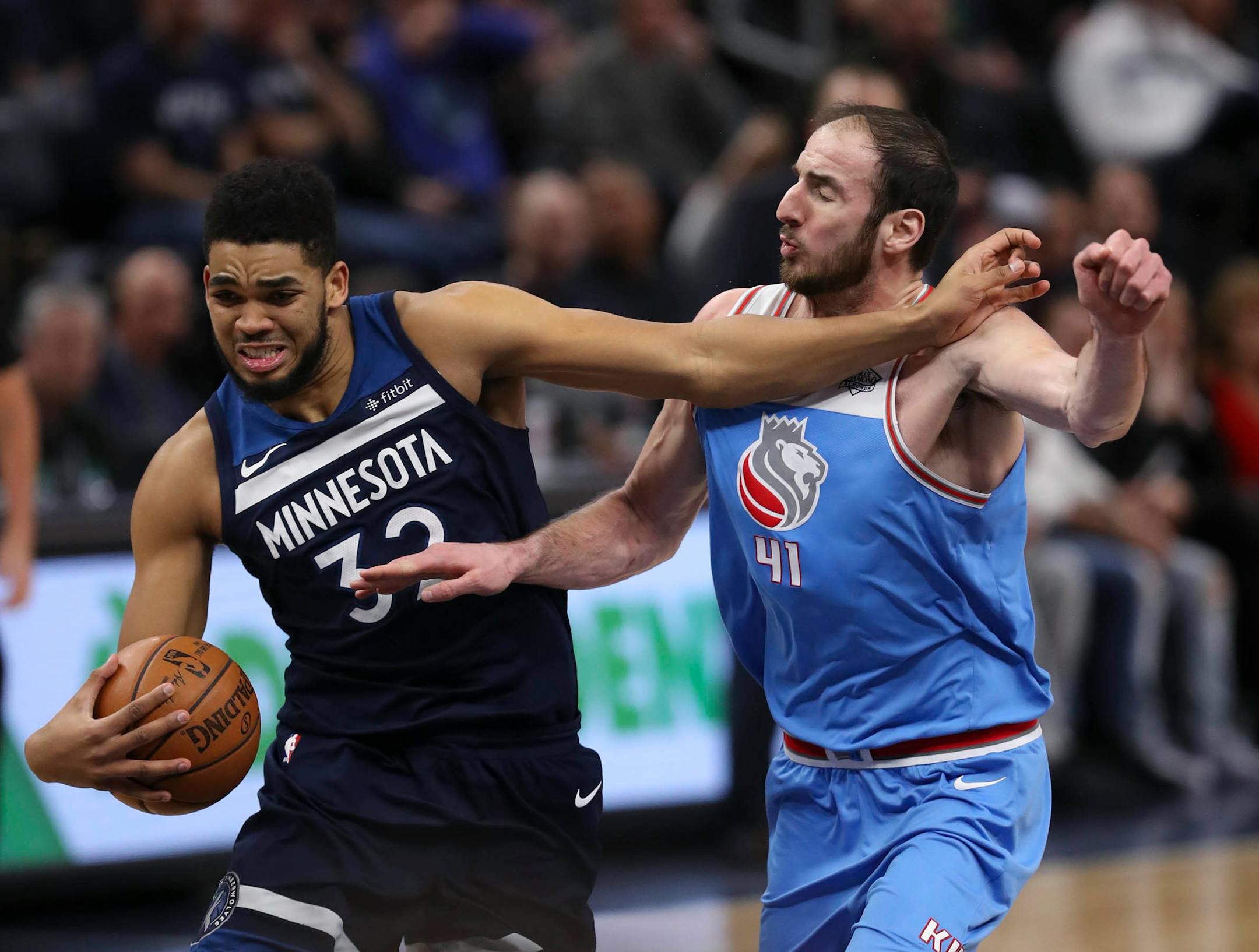 Minnesota Timberwolves center Karl-Anthony Towns (32) held off Sacramento Kings center Kosta Koufos (41), who was fouling him as he drove to the net in the fourth quarter. Towns led all scorers with 29 points.