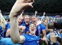 Iceland's Haukur Heidar Hauksson takes a selfie with supporters at the end of the Euro 2016 round of 16 soccer match between England and Iceland, at t