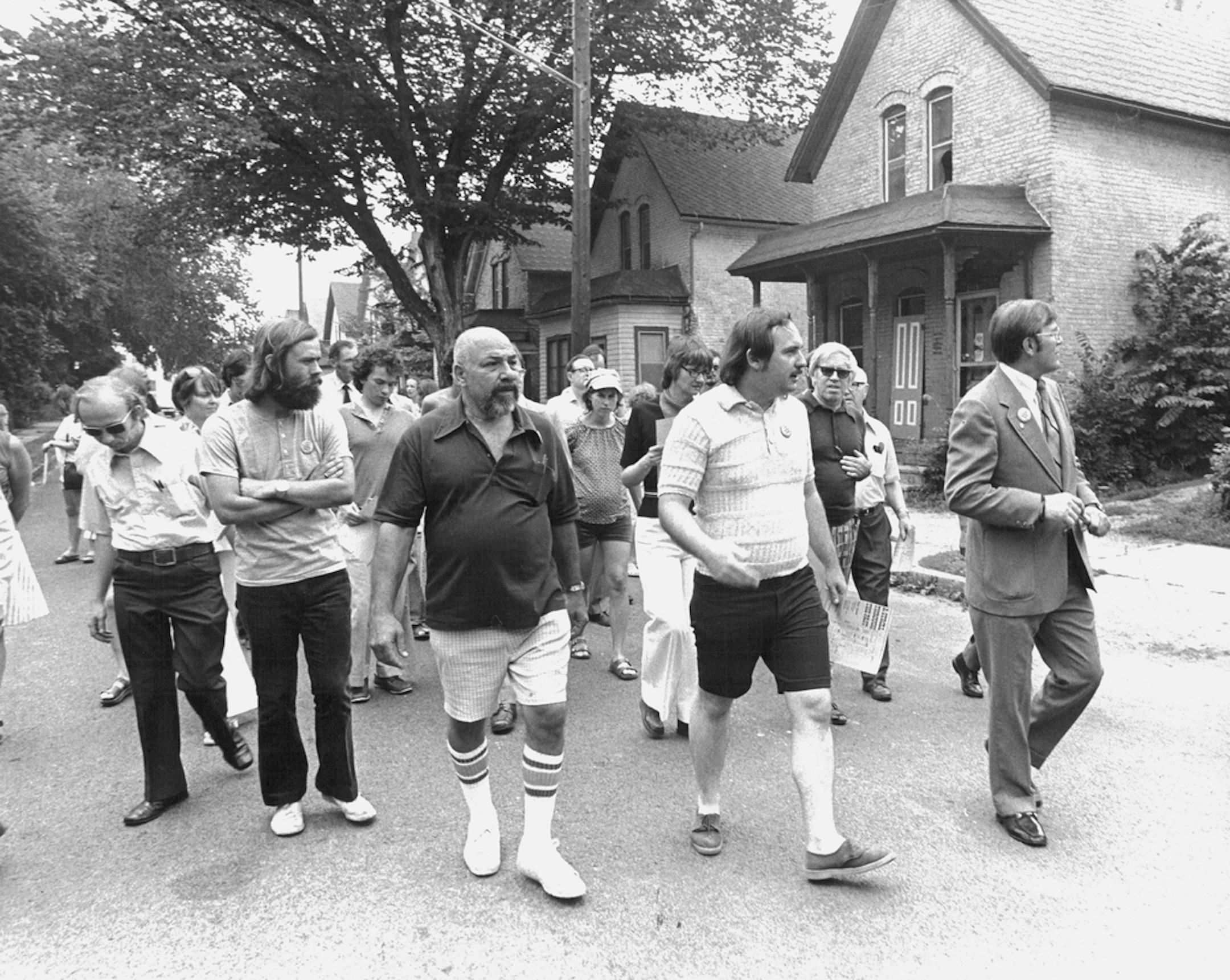 July 3, 1975 Minneapolis Mayor Albert Hofstede, right. yesÂ­terday took a walking tour of Milwaukee Av., conÂ­sidered by the Minnesota Historical Society to be one of the few intact examples of the neighborhoods inhabited by immigrants who came to Minnesota more than 100 years ago. The four-block Milwaukee Av. area, part of the city's Seward neighborhood, originally was dessignated a clearance area by the city planning commission. But recently, the HousÂ­ing and Redevelopment Authority and the S