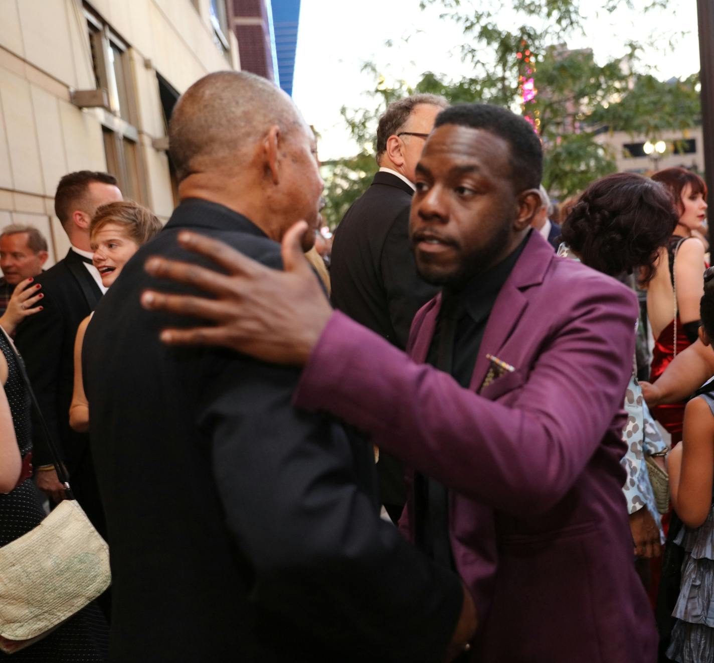 Mikell Sapp, (in purple suit) greets actor James Craven (black suit) arriving at the Ivey Awards monday in Minneapolis. The Twin Cities celebrated the 2015 Ivey Awards, Monday September 21, 2015 at the State Theater in Downtown Minneapolis. The awards were established in 2004 and are unique among awards events in the country in that they are open to the public and that there are no nominees, set number of awards or pre-determined award categories, with the exception of the Lifetime Achievement a