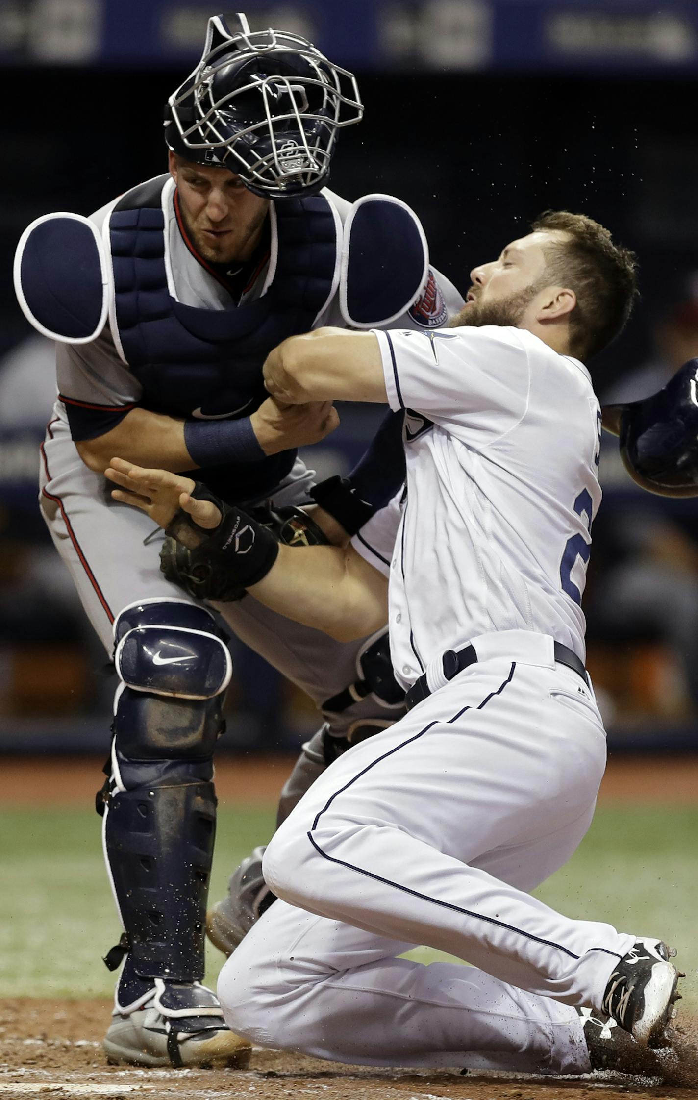 Tampa Bay Rays' Steven Souza Jr., right, crashes into Minnesota Twins catcher Mitch Garver while scoring on a sacrifice fly by Adeiny Hechavarria during the sixth inning of a baseball game, Monday, Sept. 4, 2017, in St. Petersburg, Fla. (AP Photo/Chris O'Meara)