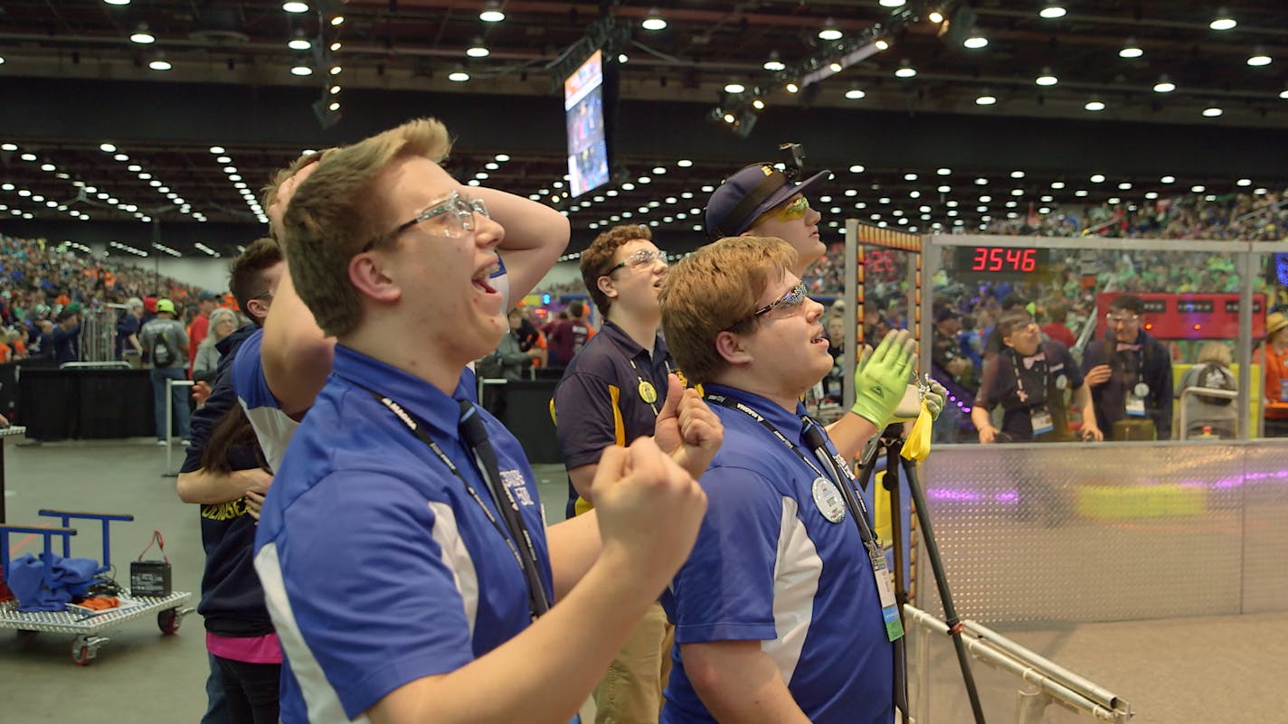 Brothers Ryan and Robert Hlucny of the Greenbush Middle River robotics team cheer their score during competition at the world championship.