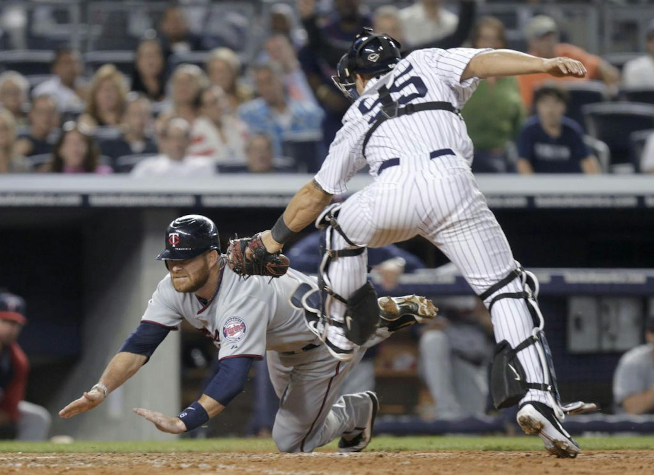 Catcher Ryan Doumit scored the Twins' sixth run with an impressive headfirst slide that enabled him to avoid the tag of Yankees counterpart Russell Martin.