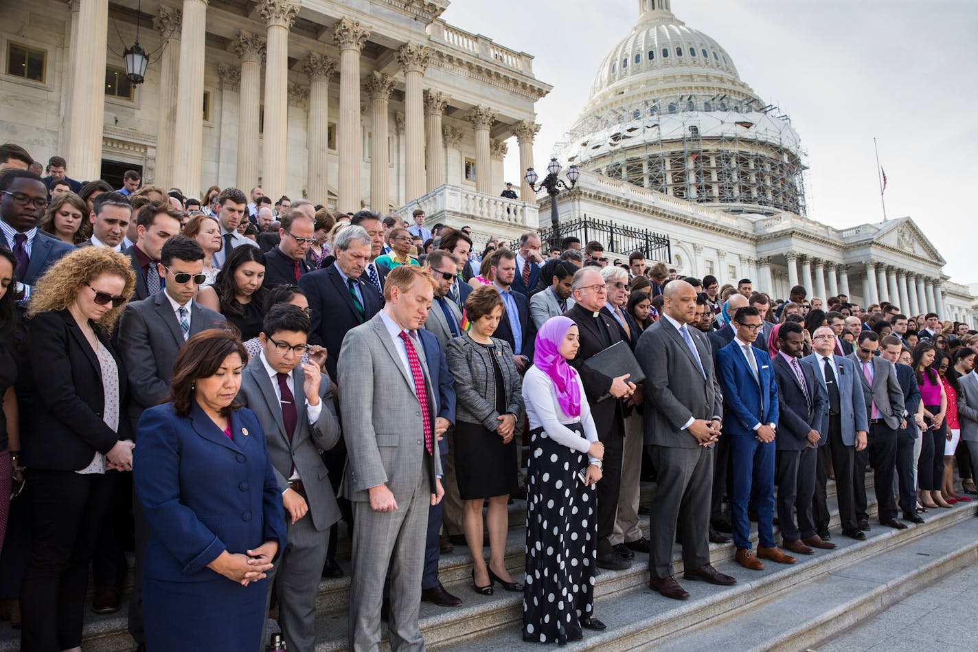 The LGBT Congressional Staff Association, the Congressional Muslim Staff Association, and members of Congress gather for a prayer and moment of silence on the steps of the Capitol to stand in solidarity with the Orlando community and to remember the victims of Sunday's shooting at an LGBT night club, in Washington, Monday, June 13, 2016. Father Patrick J. Conroy, center, chaplain of the House of Representatives, delivered an interfaith message. (AP Photo/J. Scott Applewhite)