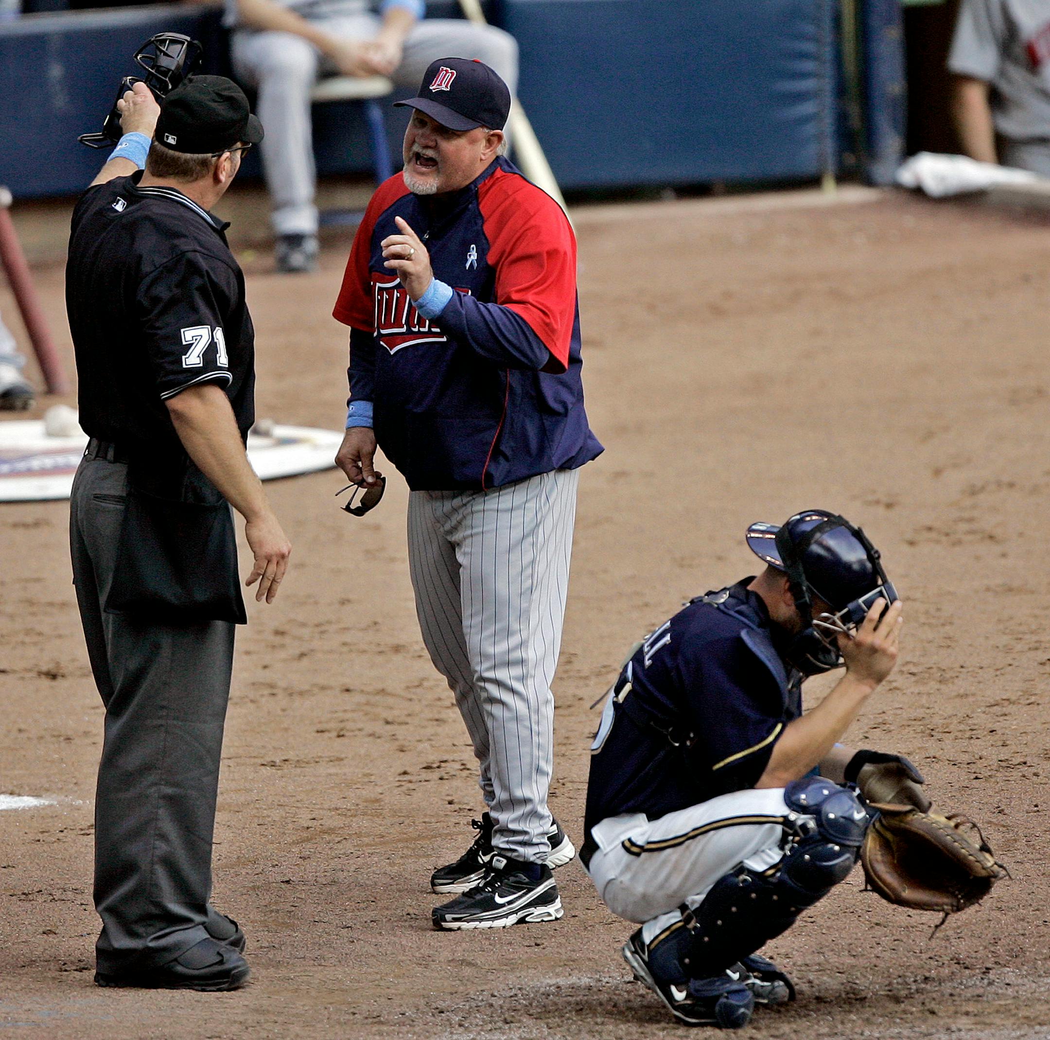 Minnesota Twins manager Ron Gardenhire, center, argues with home plate umpire Brian Runge (71) in front of Milwaukee Brewers catcher Jason Kendall during the eighth inning of a baseball game Sunday, June 15, 2008, in Milwaukee. Gardenhire was ejected from the game.