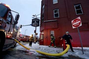 Firefighters at the scene of a fire on the 200 block of East Lake St. in Minneapolis on Sunday.