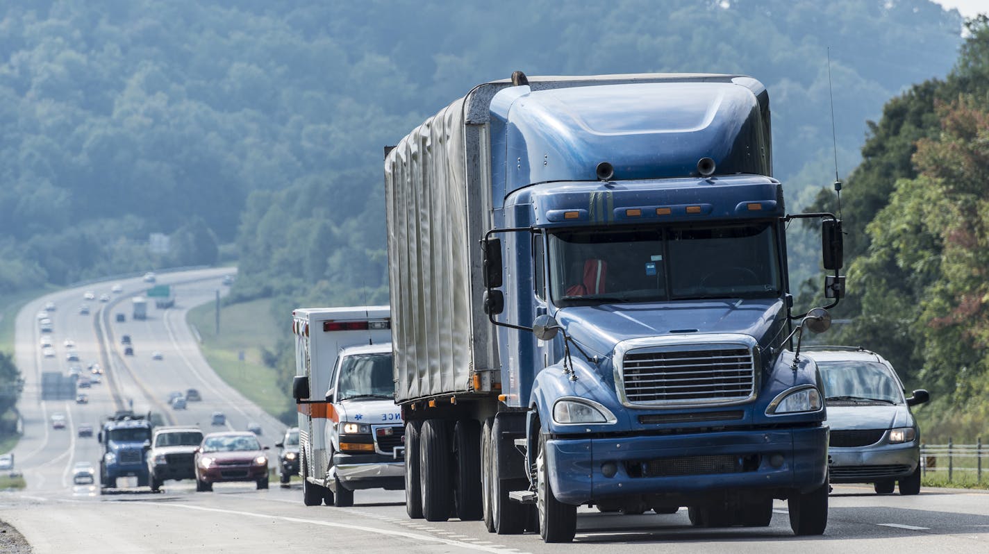 iStockphoto.com
A blue semi leads a line of interstate traffic on a foggy morning.