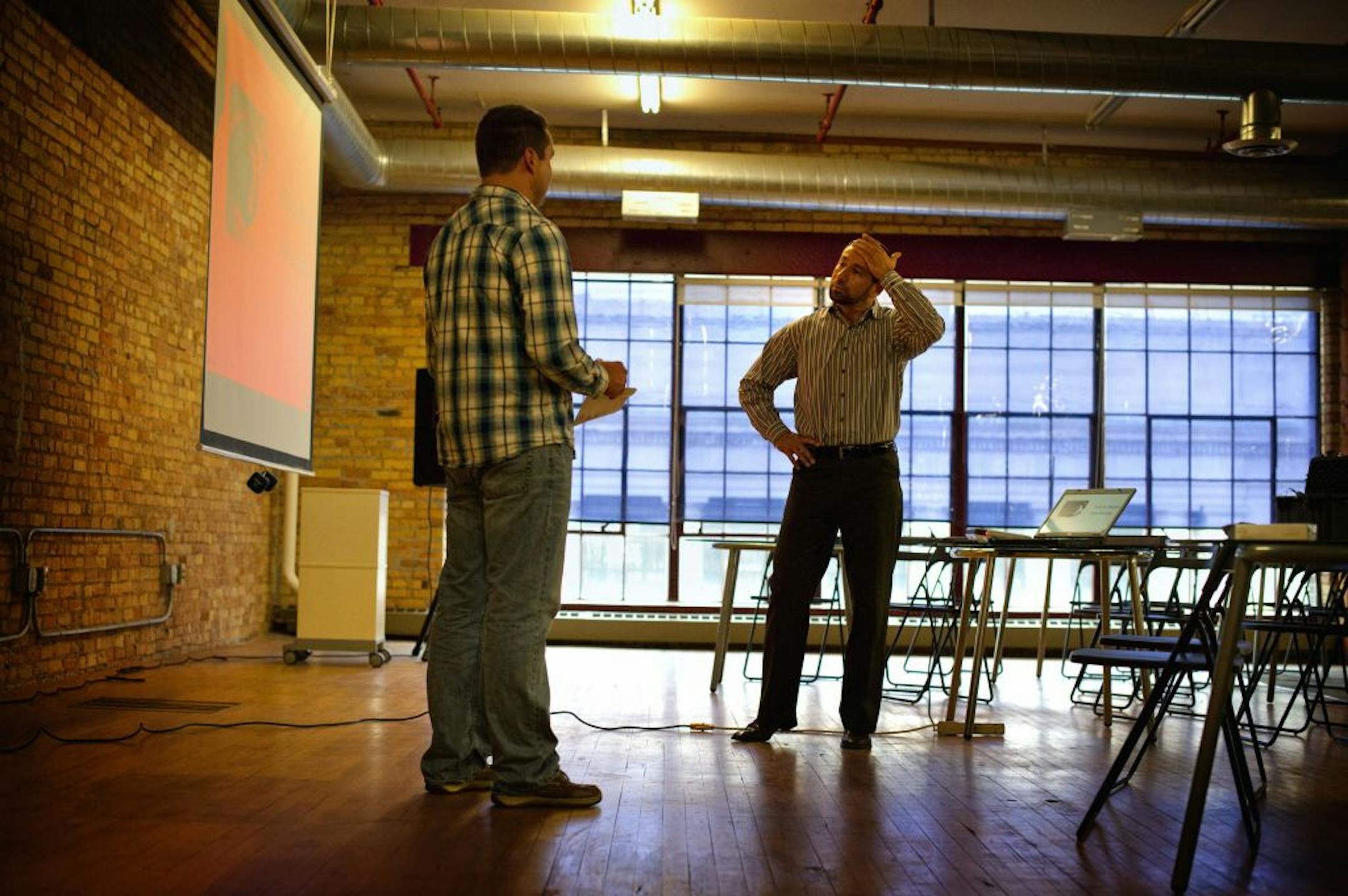 Cem Erdem of Project Skyway, right, helped Alex Reilly polish his presentation for his company, CribFrog, a social networking site for apartment tenants.