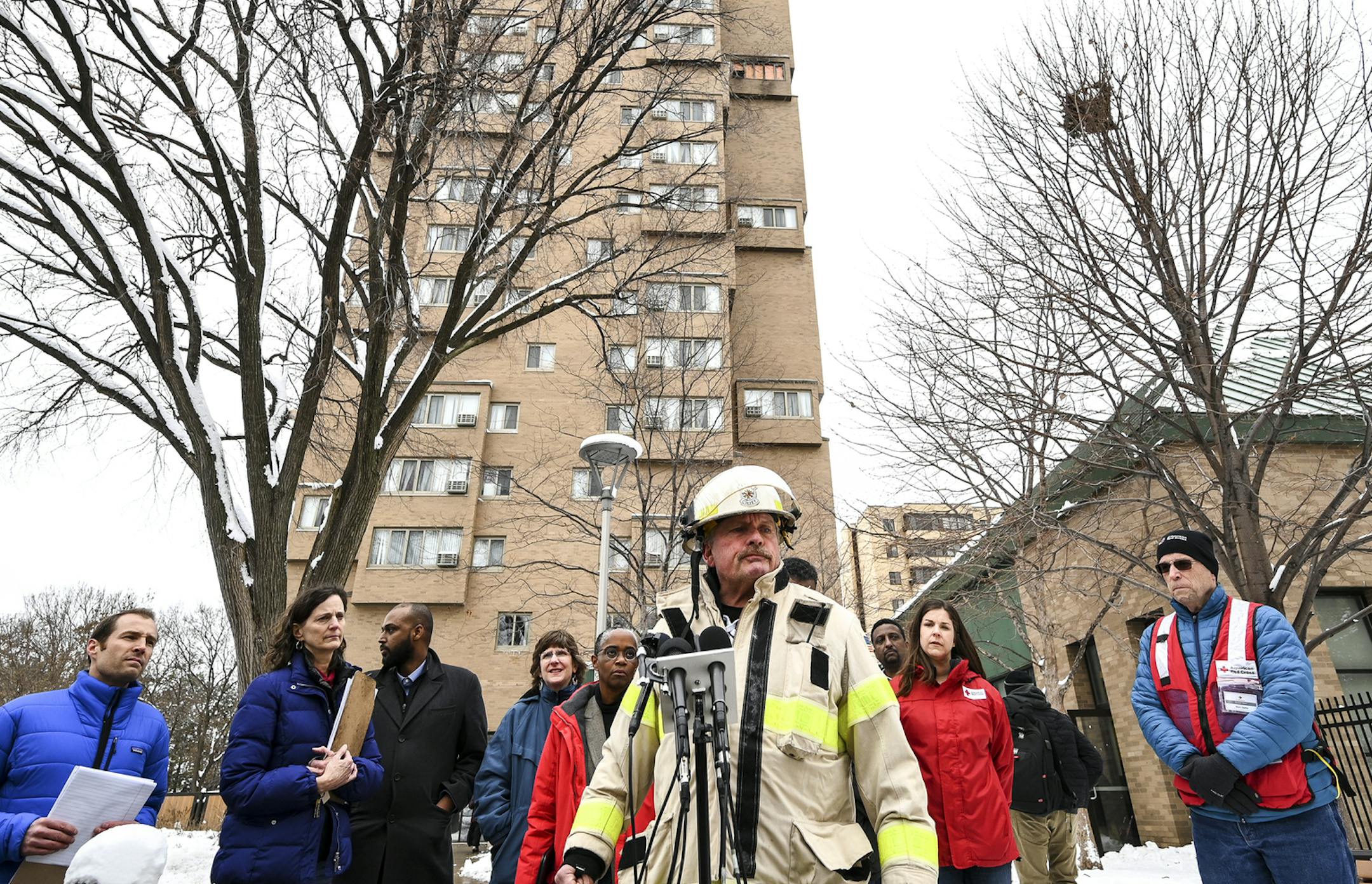 Minneapolis Fire Department Chief John Fruetel speaks to the media in front of the building at 630 Cedar Avenue where an early morning fire killed multiple people Wednesday, Nov. 27, 2019 in Minneapolis. Residents of the high rise were evacuated early Wednesday after a fire broke out on the 14th floor of the building. (Aaron Lavinsky/Star Tribune via AP)