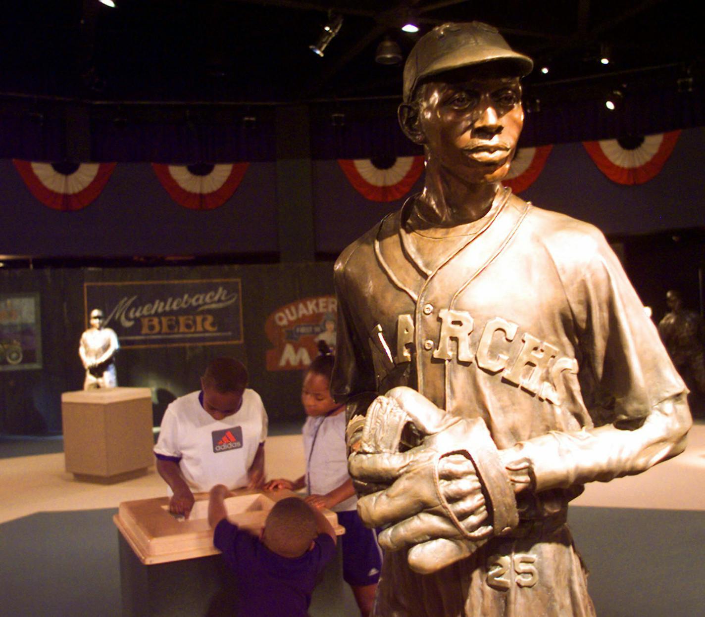 ** ADVANCE FOR WEKEND OF DEC. 6-7 -- FILE ** Visitors test their Negro Leagues Baseball knowledge at one of the many state-of-the-art interactive computer stations, in this July 13, 2000, file photo at the Negro Leagues Baseball Museum in Kansas City, Mo. The museum features 12 life-sized bronze sculptures of Negro Leagues star players. Washington lawmakers will consider in Dec. 2003, giving amounts to help keep black museums afloat. Among the proposed grants in this bill is $800,000 for the Neg