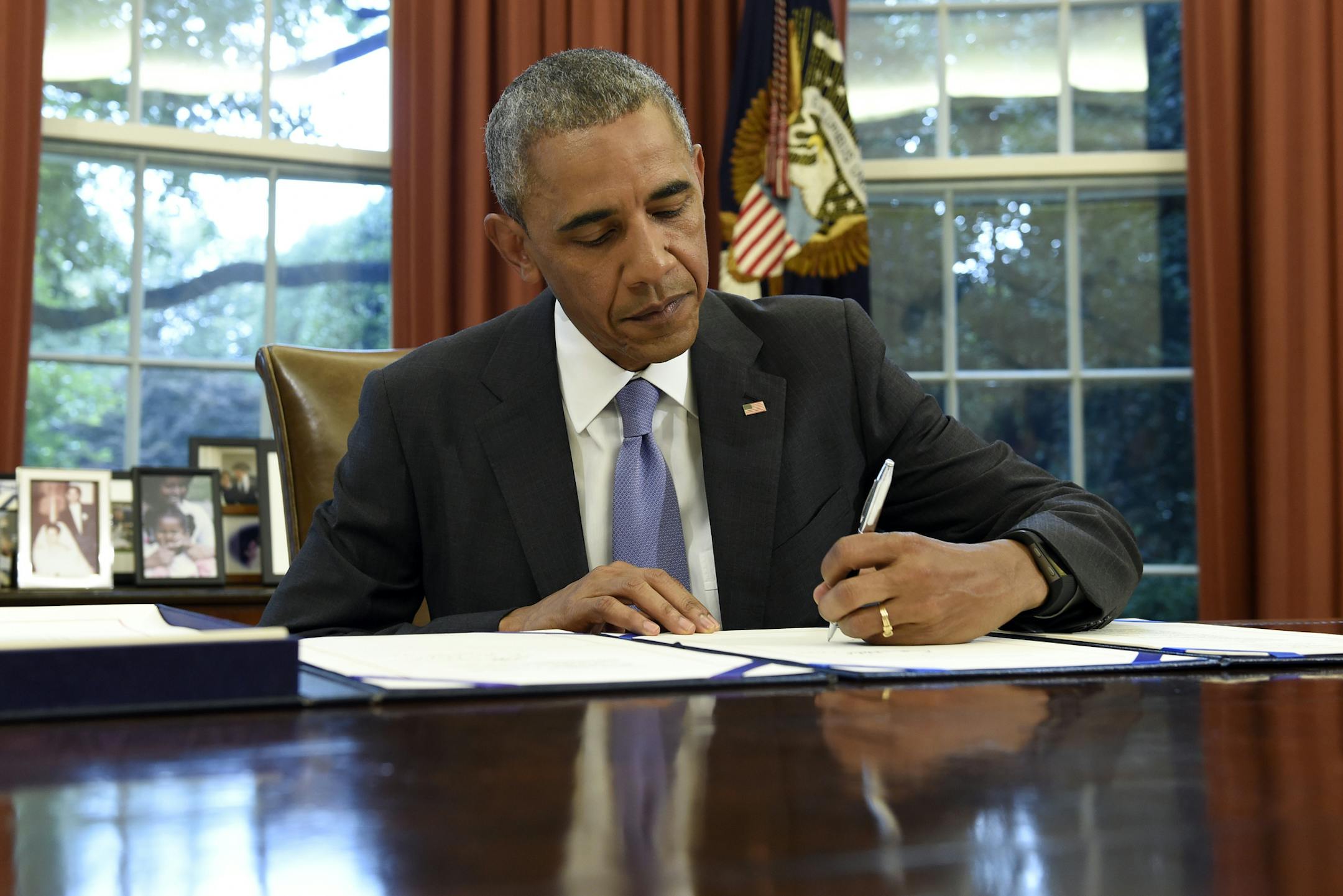 President Barack Obama signs the FOIA Improvement Act of 2016 in the Oval Office of the White House in Washington, Thursday, June 30, 2016. Obama also signed the Puerto Rico Oversight, Management, and Economic Stability Act. (AP Photo/Susan Walsh) ORG XMIT: DCSW108