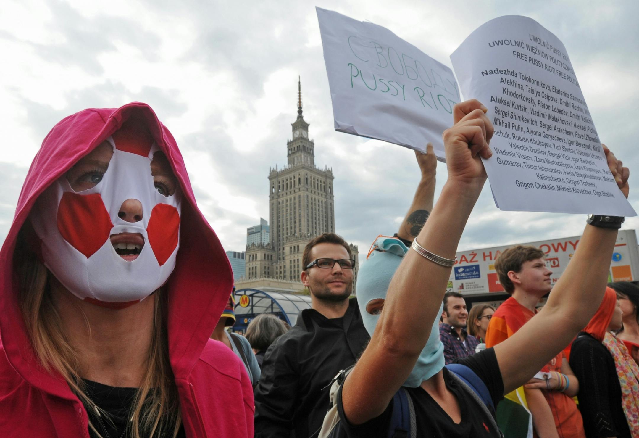 April 17, 2013: Supporters of the Russian punk group Pussy Riot hold up banners reading at left: "Free Pussy Riot", as they walk through downtown Warsaw, Poland.