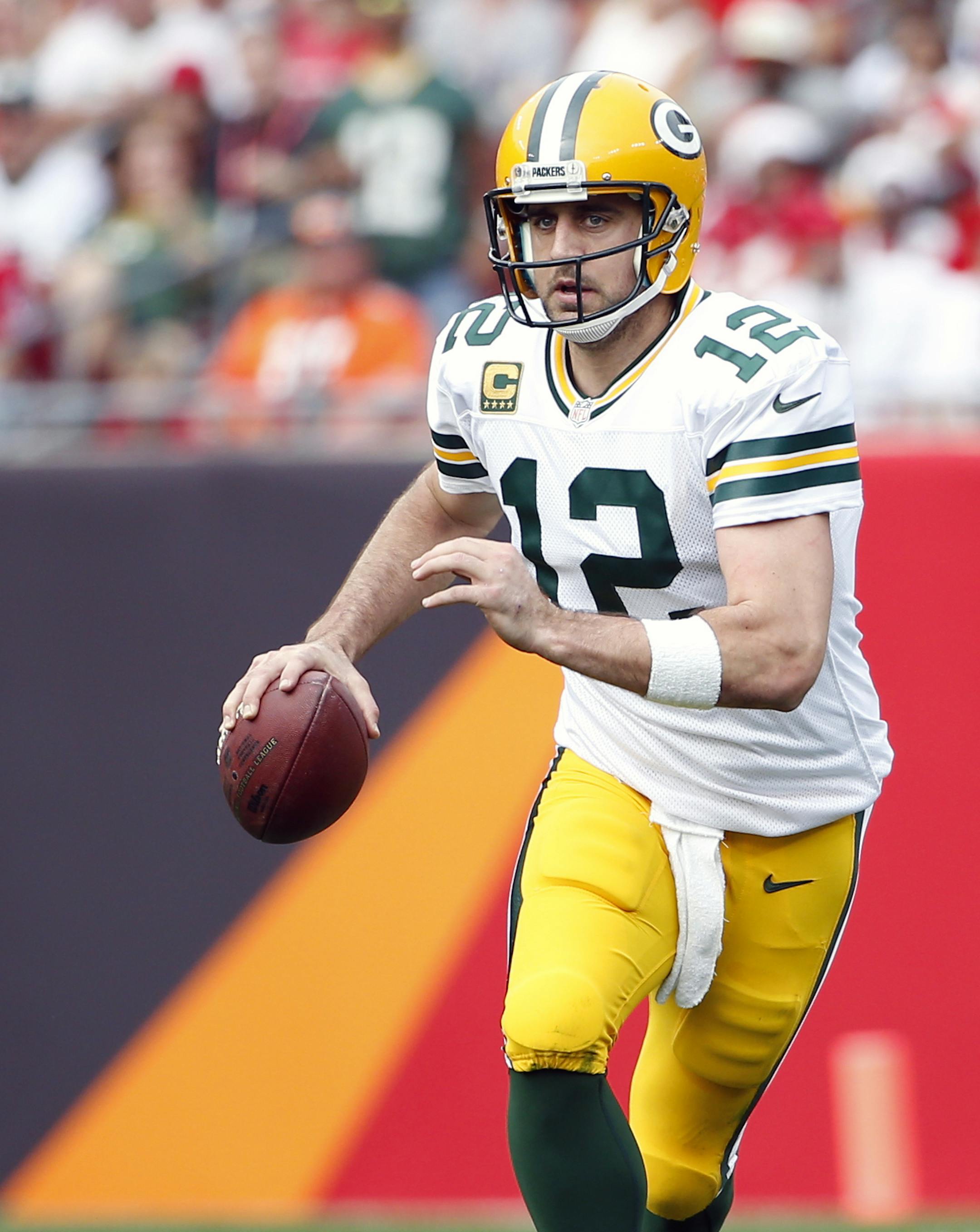 Green Bay Packers quarterback Aaron Rodgers (12) looks for an open receiver during an NFL football game against the Tampa Bay Buccaneers on Sunday, Dec. 21, 2014, in Tampa, Fla. (AP Photo/Brian Blanco)