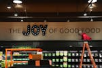 Workers install signs at the new Kowalski’s Market in Southdale Center’s new luxury wing Friday in Edina.