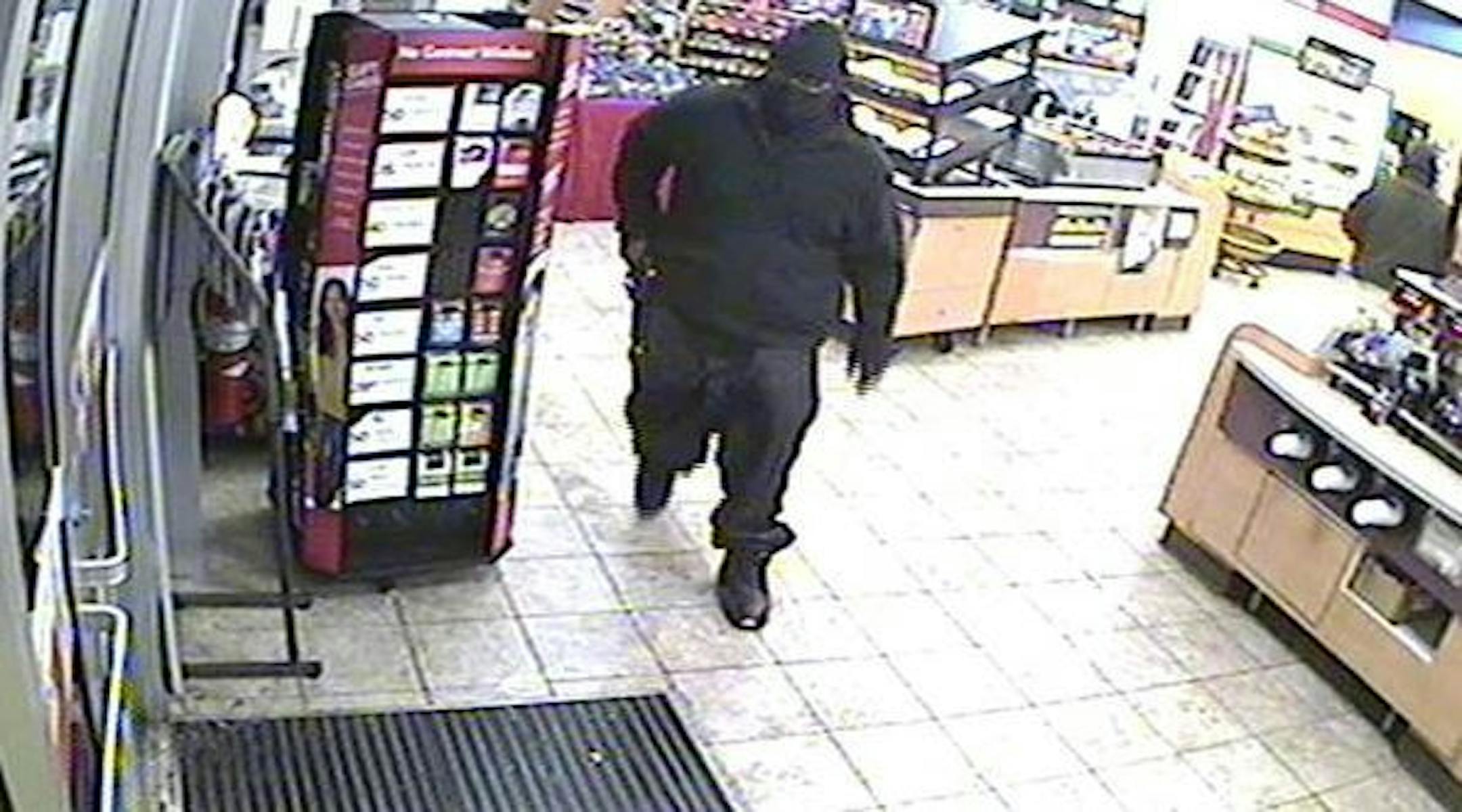 This man, shown robbing a SuperAmerica store at 4320 E. Lake Street in Minneapolis, is suspected in five store hold-ups on Tuesday, Dec. 31.