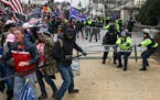 FILE - Supporters of President Donald Trump fight with police outside the Capitol in Washington, Jan. 6, 2021.
