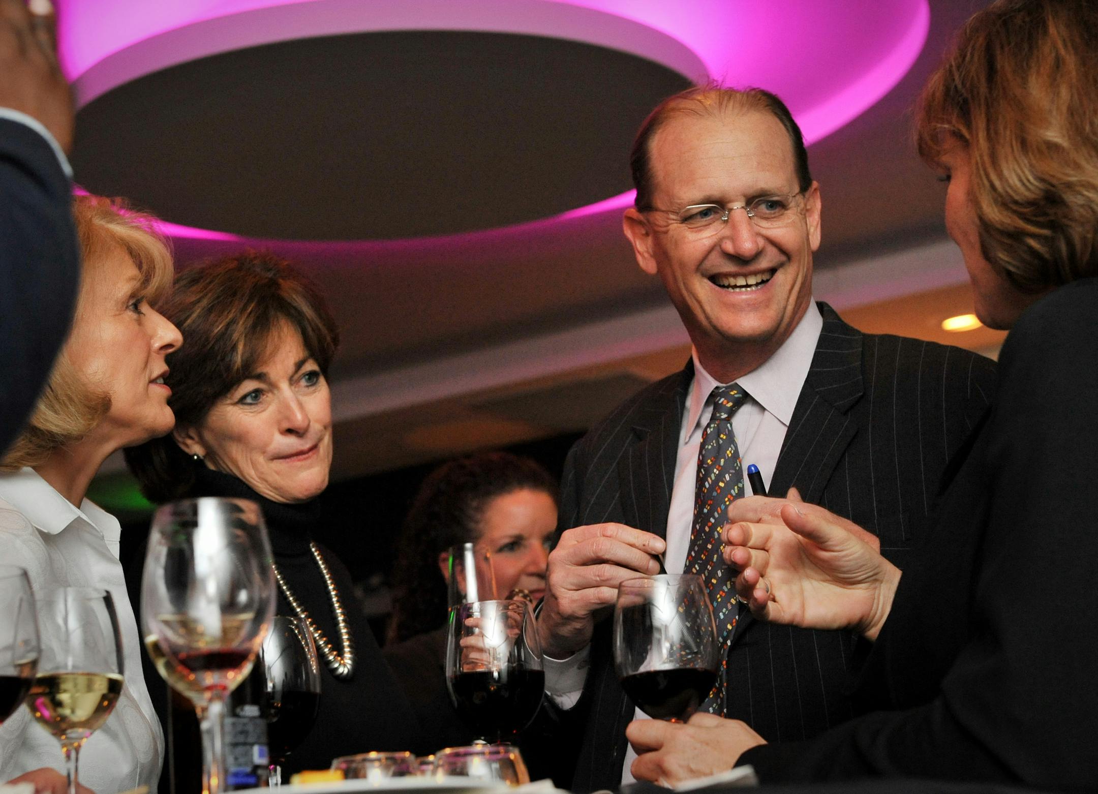 Delta Airlines CEO Richard Anderson mingled at a Delta Airlines wine tasting where Northwest Airlines flight attendants were introduced to Delta's wine list. On the left are Donna Watsona 41-year NWQ flight attendant and Joanne Smith, senior vice president of In-Flight Service and Global Product Development for Delta Air Lines.