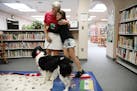 Jan Rempher and her therapy dog Arthur, a 5-year-old English Springer Spaniel, got hugs from Layla Larsen, 9, a fourth grader at Sioux Trail Elementar