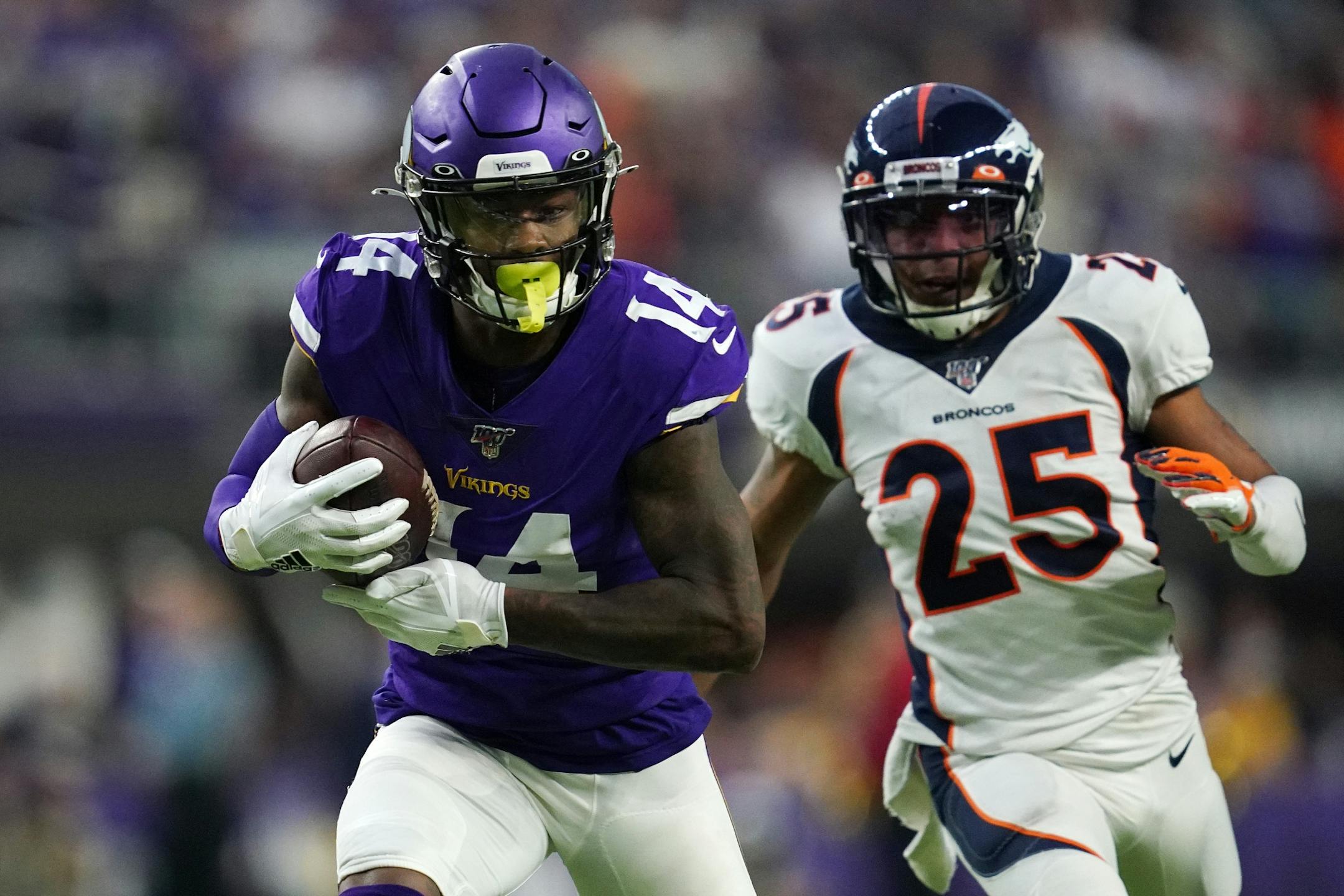 Minnesota Vikings wide receiver Stefon Diggs (14) completed a long pass by quarterback Kirk Cousins (8) to run it in for a touchdown in the fourth quarter.