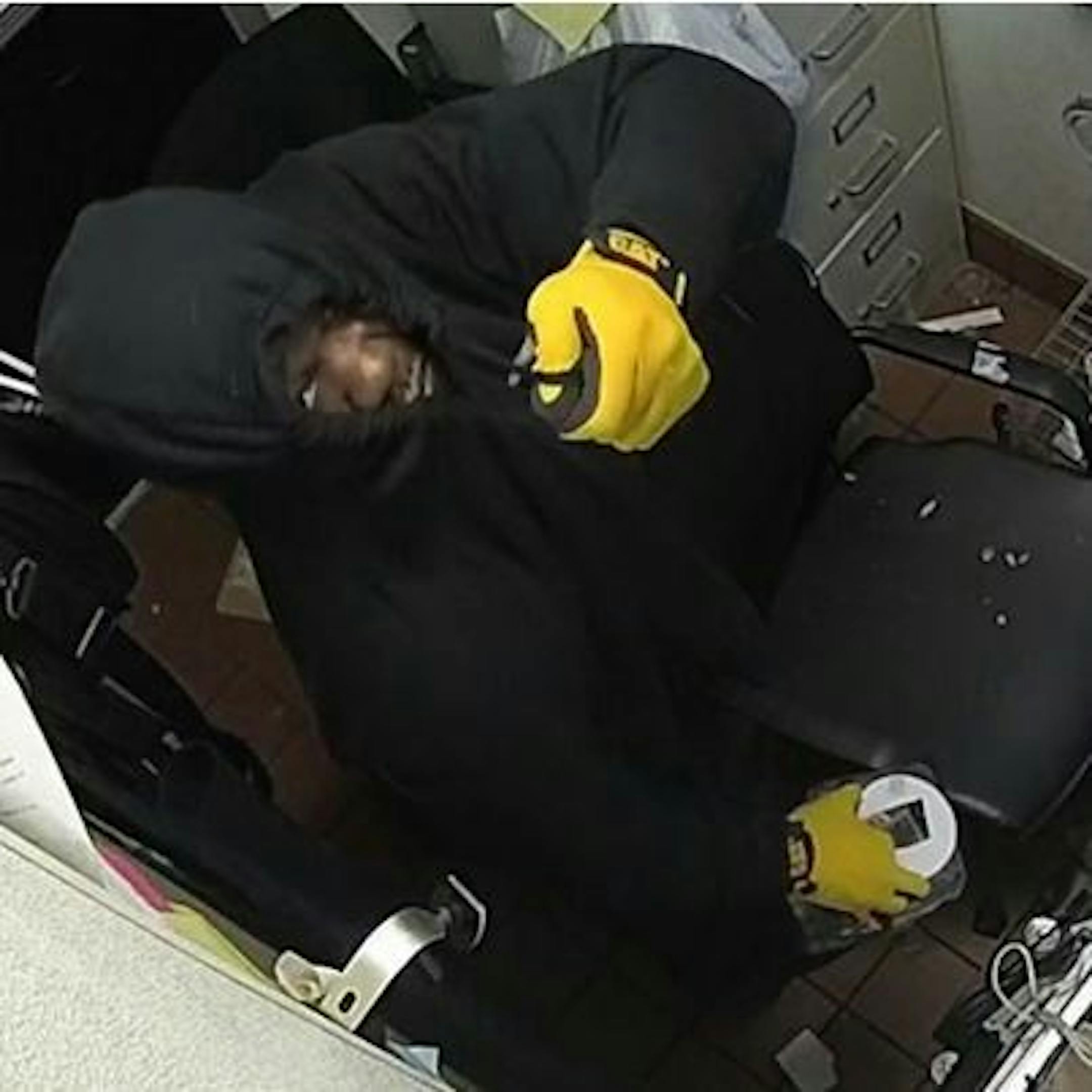 The suspect in a string of restaurant burglaries in White Bear Lake has worn a dark hoodie and yellow gloves.