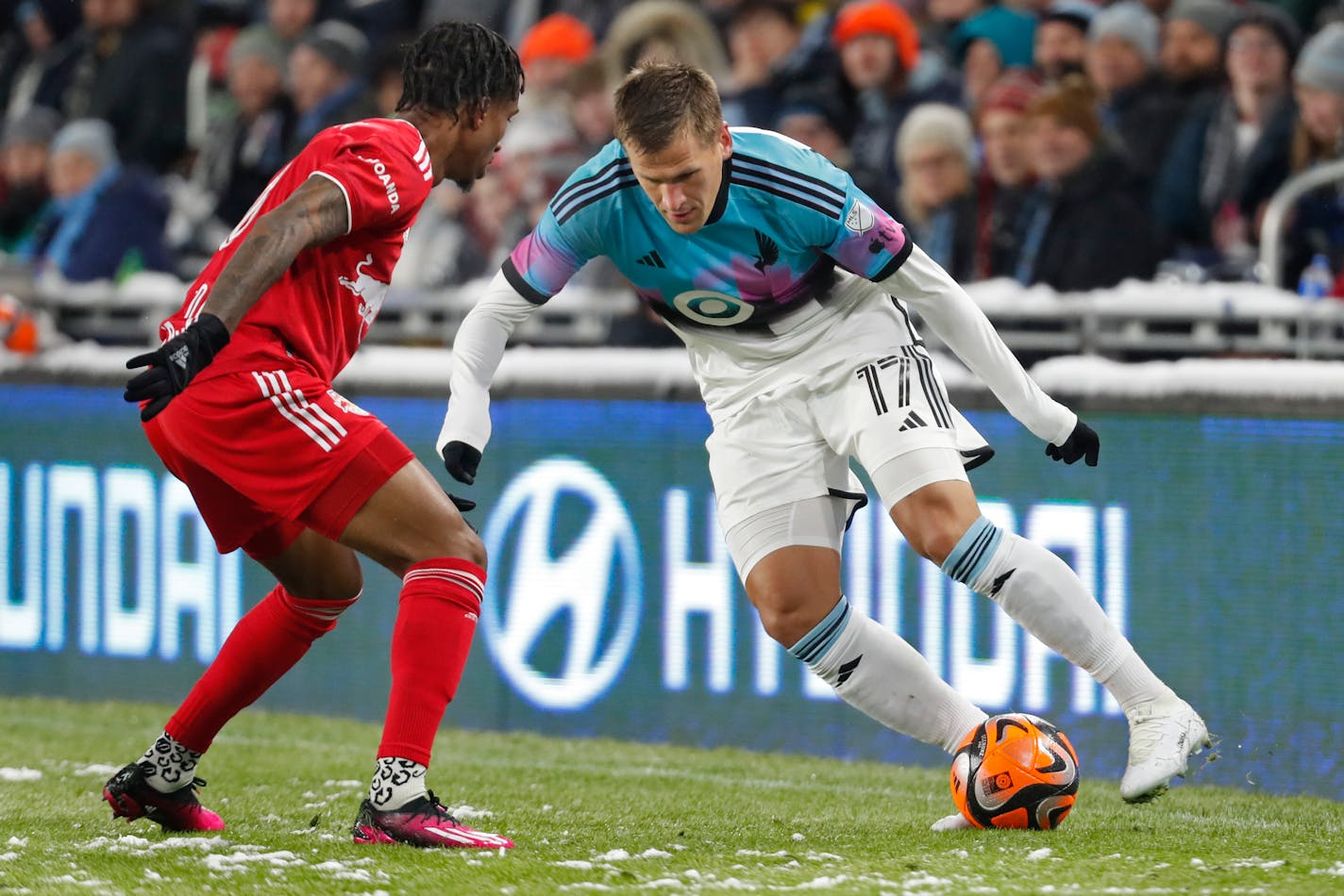 Minnesota United midfielder Robin Lod (17) cuts back to get around New York Red Bulls defender Kyle Duncan, left, in the second half of an MLS soccer game Saturday, March 11, 2023, in St. Paul, Minn. (AP Photo/Bruce Kluckhohn)