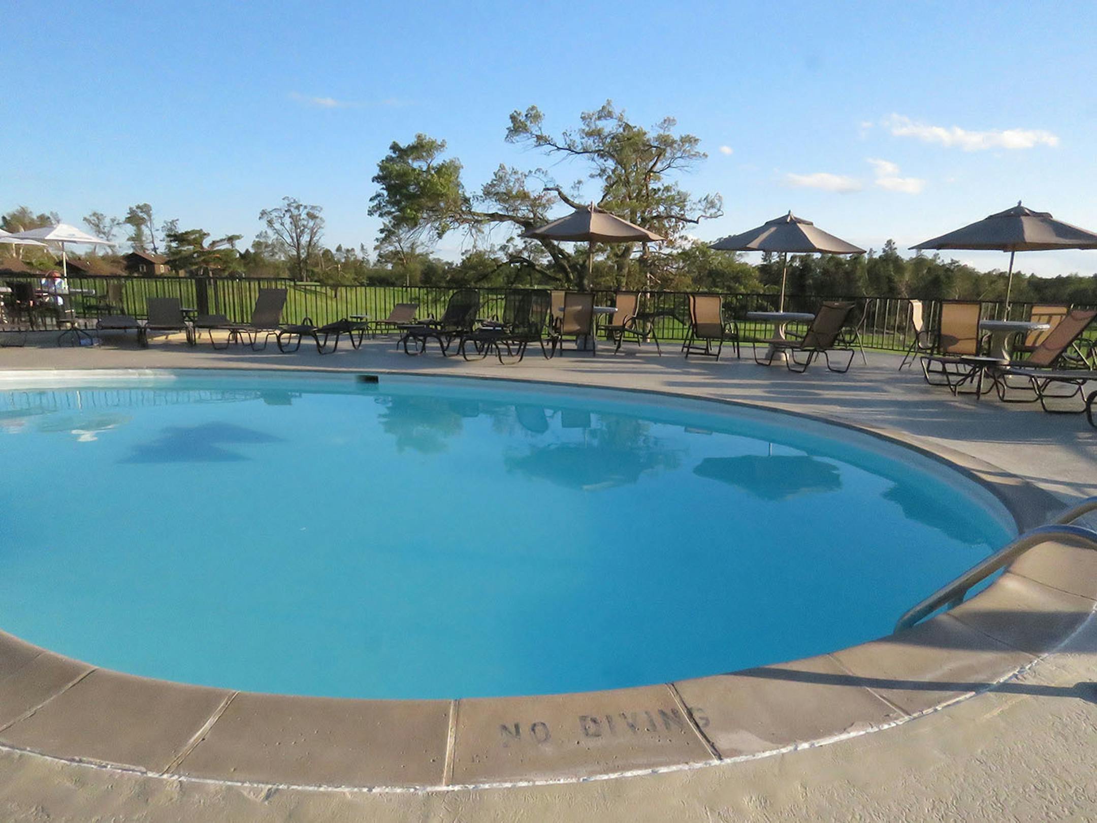 The outdoor pool and spacious patio at Madden Inn and Golf Club offer elevated views of the Pine Beach East golf course as well as Gull Lake on either side of the peninsula.