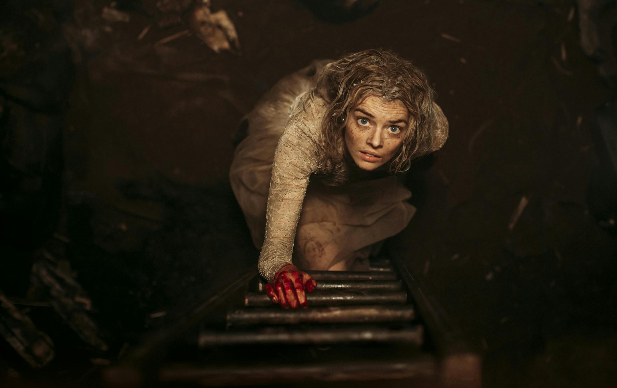 This image provided by Fox Searchlight Pictures shows Samara Weaving in the horror film “Ready or Not.” Weaving plays a bride who tries to stay alive until dawn on her wedding day as her in-laws hunt her down and try to kill her. (Eric Zachanowich/Fox Searchlight Pictures via AP)