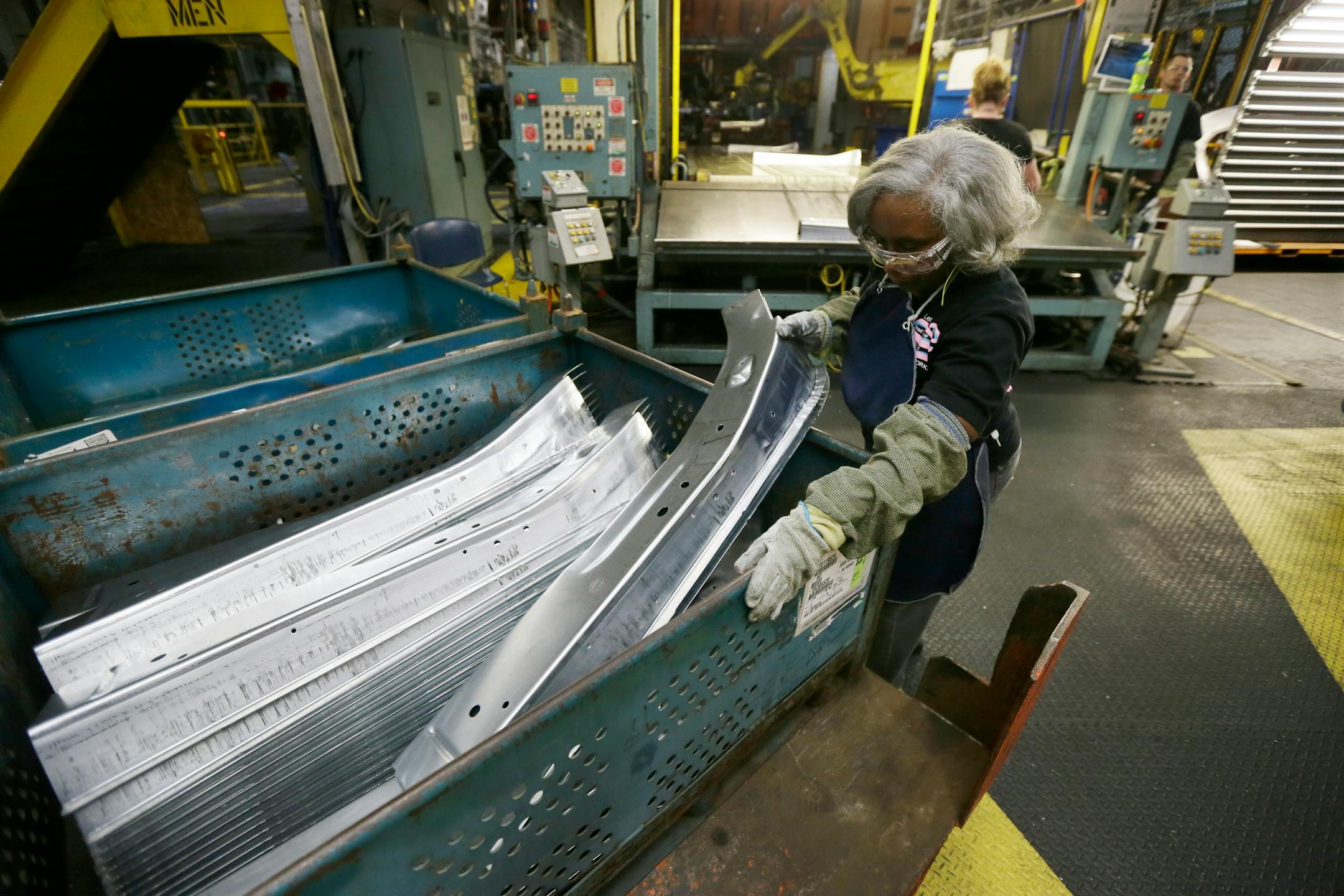 United Auto Workers line worker Vanassa Stafford loads a bin with stamped parts at the General Motors Pontiac Metal Center in Pontiac, Mich., Thursday, April 30, 2015. The automaker plans to spend $5.4 billion to improve its U.S. factories during the next three years, creating about 650 new jobs. (AP Photo/Carlos Osorio)
