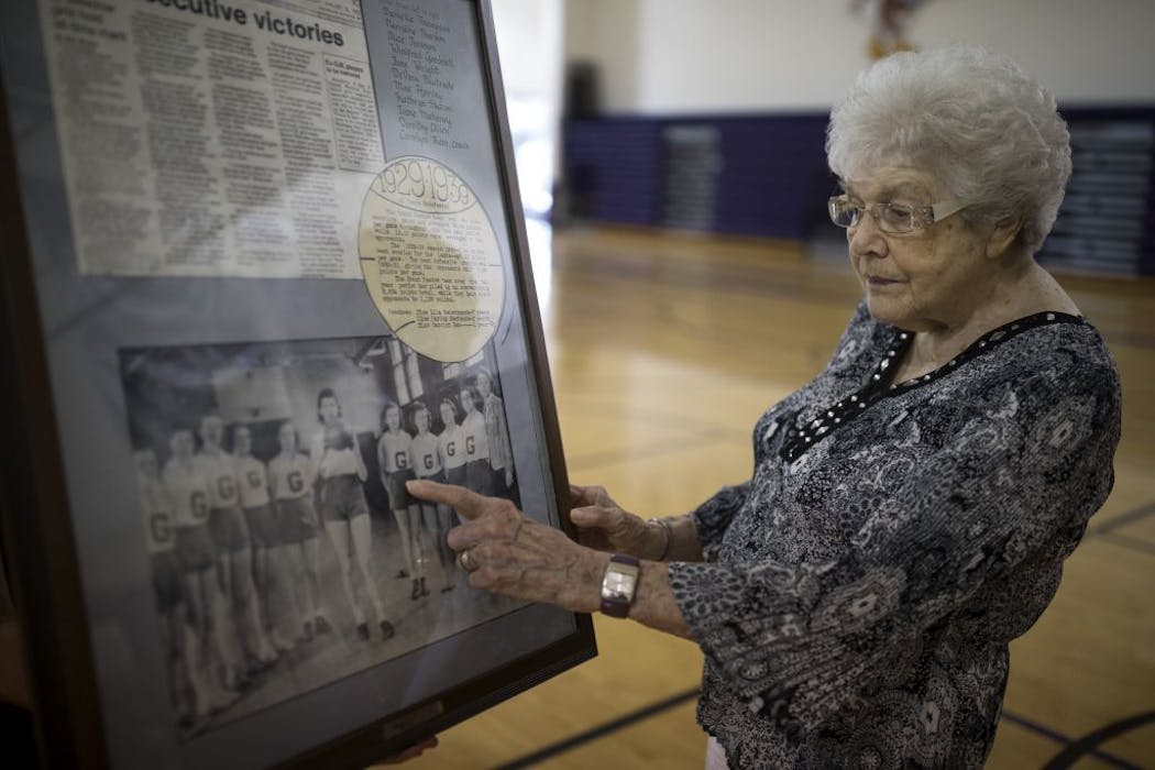Mae Gross 97 ,pointed at herself in an old photograph that hangs at Grand Meadow basketball gym.