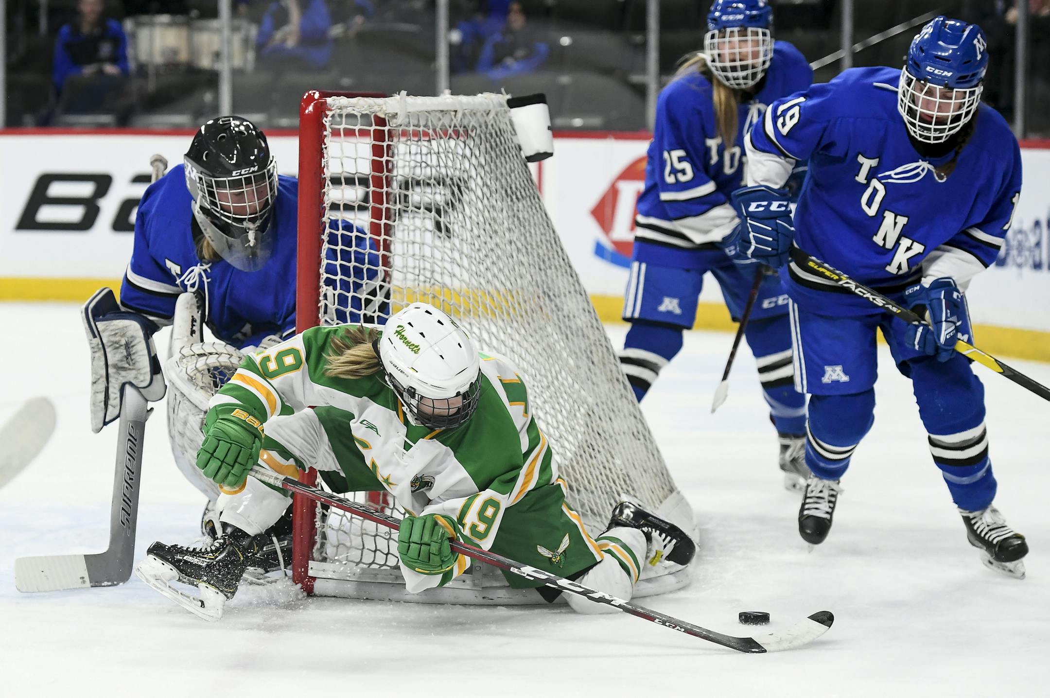 Edina forward Tella Jungels (19) struggled to control the puck as she tried a wraparound against Minnetonka goaltender Brynn Dulac (1) in the first period. ] Aaron Lavinsky ¥ aaron.lavinsky@startribune.com Edina played Minnetonka in a Class 2A girls' hockey state tournament semifinal game on Friday, Feb. 22, 2019 at the Xcel Energy Center in St. Paul. Minn.