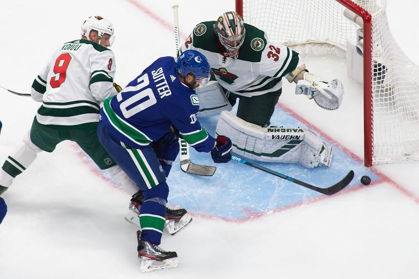 Vancouver Canucks' Brandon Sutter (20) takes a shot on Minnesota Wild goaltender Alex Stalock (32) during the second period of an NHL hockey playoff game Sunday, Aug. 2, 2020, in Edmonton, Alberta.