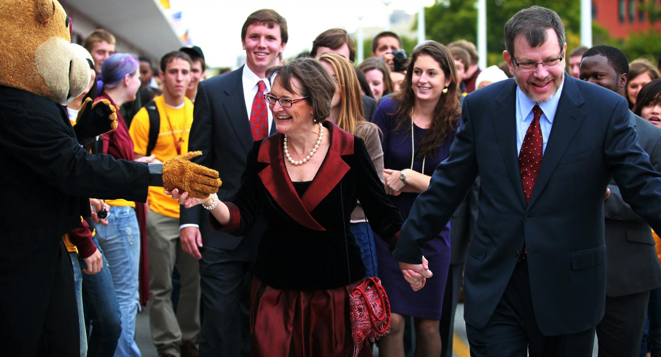 U President Eric Kaler and his wife, Karen Kaler, walked across the Washington Avenue Bridge on Thursday, greeting students and Goldy Gopher.