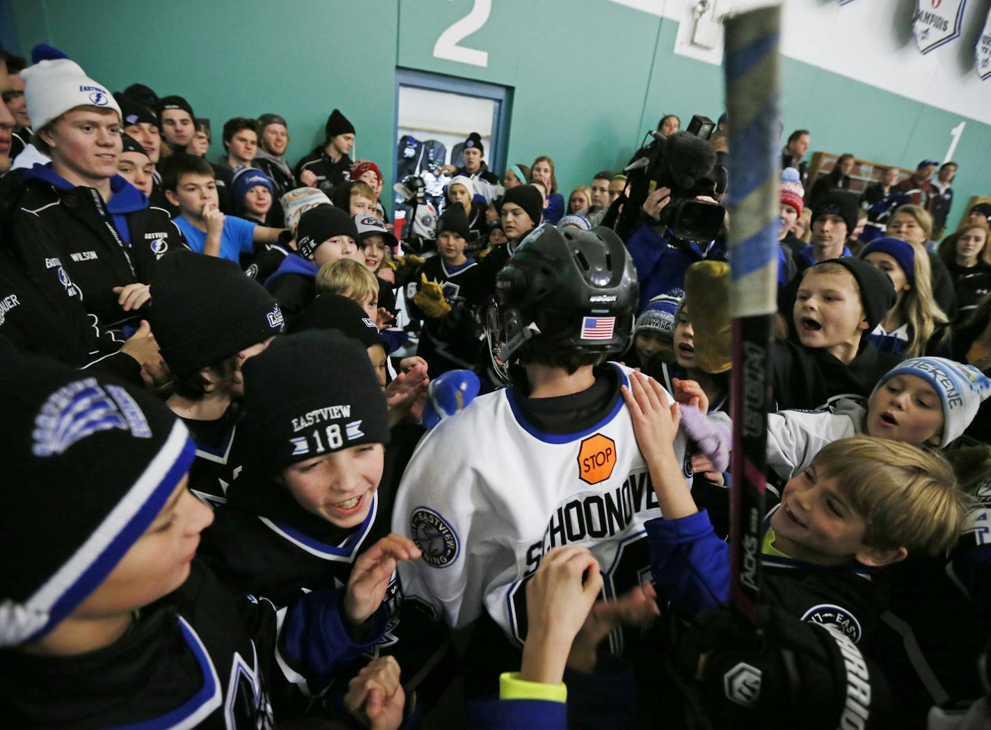 Matthew Schoonover wearing his brother Patrick jersey was greeted by fans from the Easterview community after playing a hockey scrimmage game at Hayes Arena Sunday November 16, 2014 in Apple Valley, MN. Matthew celebrated his 12th birthday on Sunday and wore his brother's Patrick jersey number 96 who died Friday after collapsing on the ice. ] Jerry Holt Jerry.holt@startribune.com